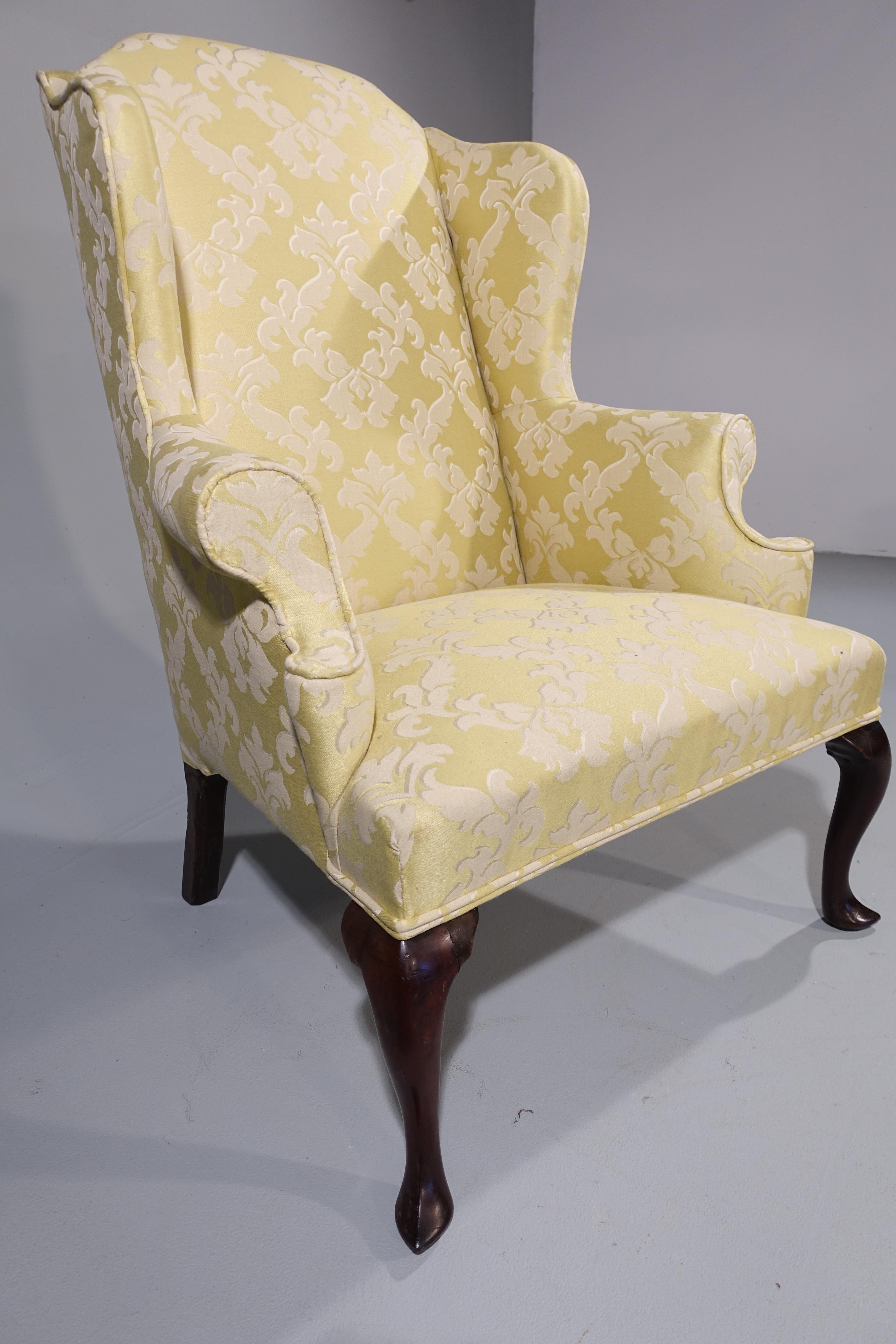 A most shapely Queen Anne design walnut framed wing chair. The wings particularly well-shaped. On short cabriole supports. Entirely recovered in our won workshop in a Gainsborough classical Damask.

Measures: Seat height 17 inches.