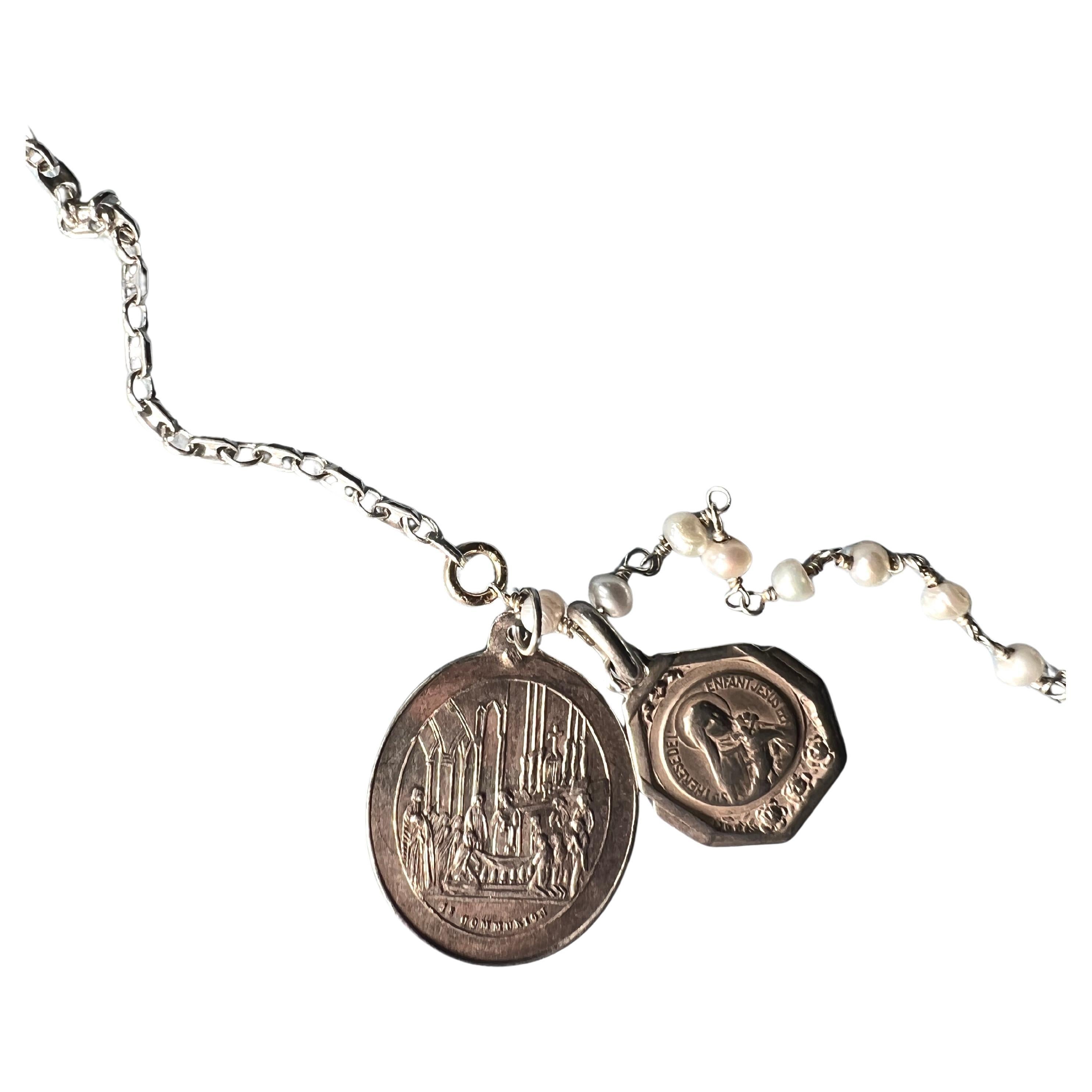 Vintage Double Medals Necklace in Silver on a Silver Pearl Rosario Chain 

Length: 23 Inches

Vintage Medals from Paris
Material: Solid Silver Medal, Silver Rosario Pearl Chain 

Pearl Rosary Necklace – Communion & St. Thérèse de l’Enfant Jésus
This