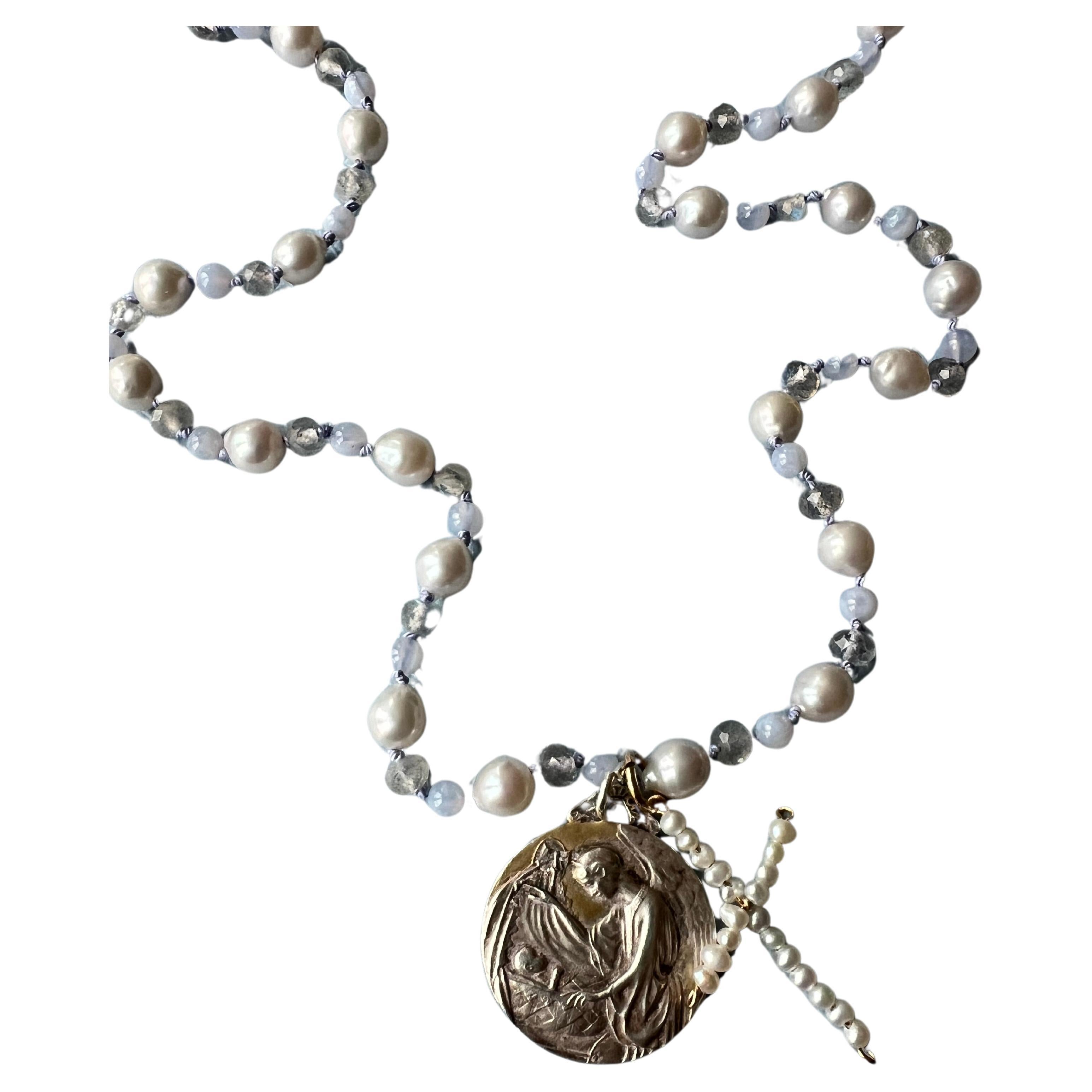 Mother Mary Jesus Child Silver Plated Medal and White Pearl Cross hanging on a White Pearl, Grey Labradorite and a Lilac Bead Choker Necklace
with a Gold Filled Clasp

40 cm

Designer: J DAUPHIN 

Made in Los Angeles

Available for immediate