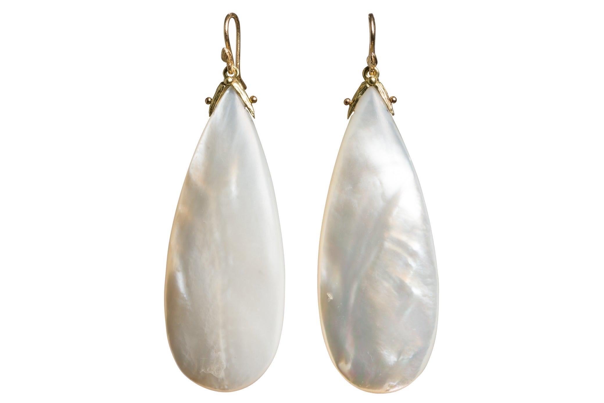 Delightfully large whilst lightweight elongated mother of pearl teardrop add a natural irridesence to even the most modest of outfits. Flirtatious and dramatic, day or night .... gabrielle's double seed signature setting and seed earwires.