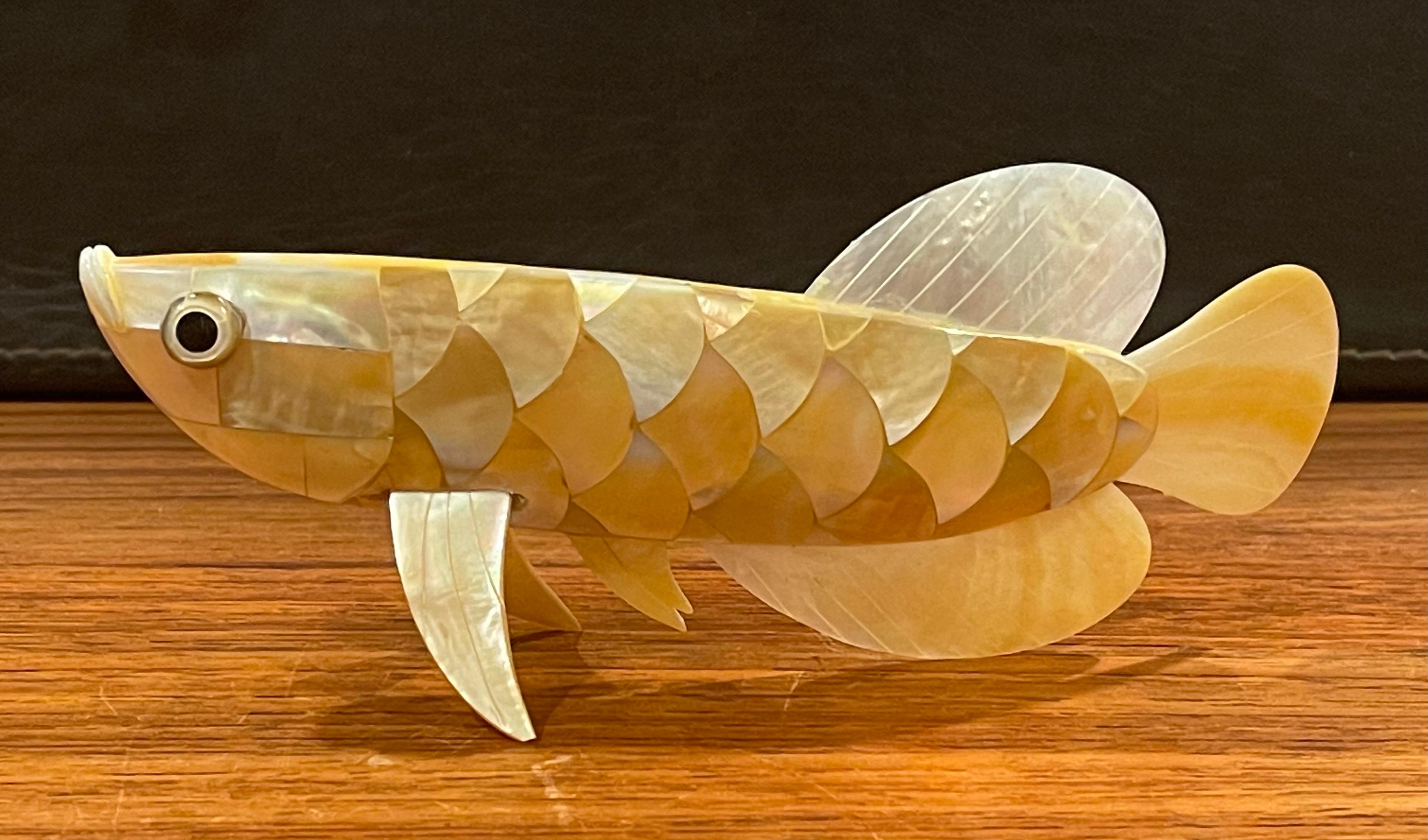 A vey nice mother of pearl / abalone shell handmade fish sculpture, circa 1990s. The piece is well detailed and the craftsmanship is amazing. The sculpture is in very good condition; with one small piece of shell is missing (please see pictures) but