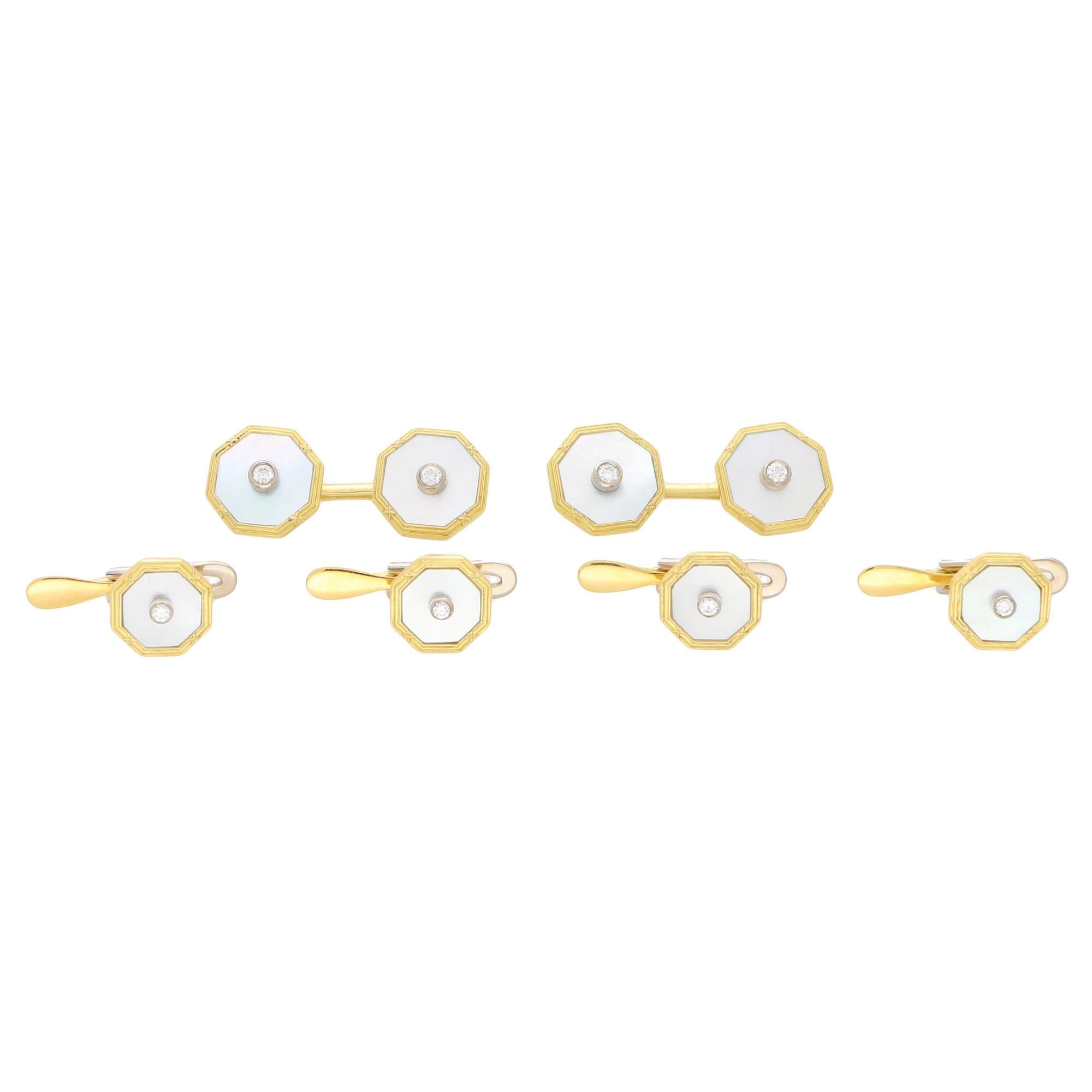 A lovely set of mother-of-pearl and diamond cufflinks and dress studs in 18k yellow gold. 

The set consists of a beautiful pair of octagonal double-sided bar chain cufflinks and four matching dress studs. Each face is centrally rub over set with a