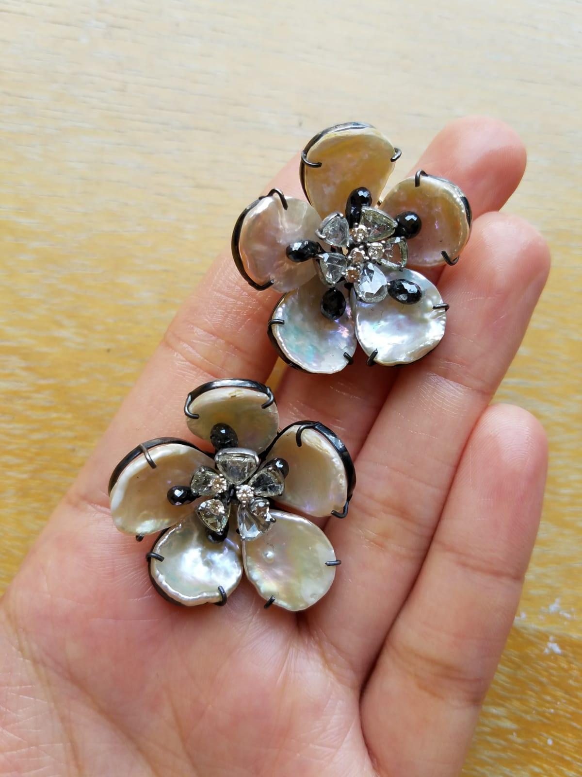 A pair of floral Mother of Pearl and black and white Diamond earrings set in Silver. These earrings truly do make a statement!
