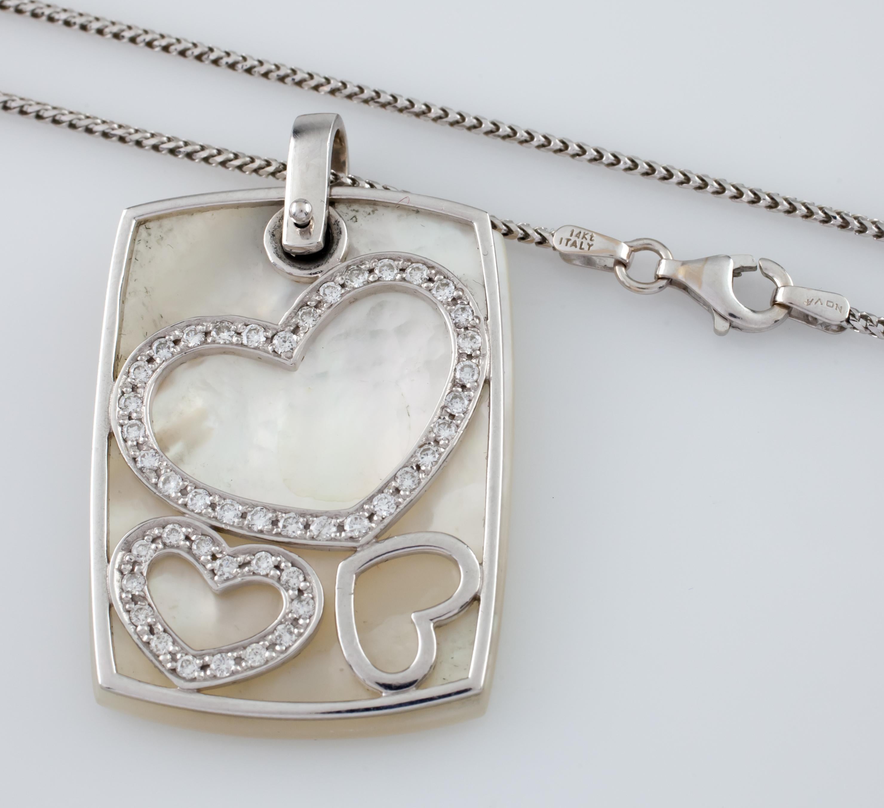 Gorgeous and Unique Mother-of-Pearl, 14k White Gold, and Diamond Pendant
14k White Gold Wire Frame Features Heart Outlines with Pave Diamonds
Mother-of-Pearl Pendant Articulates From Frame but Serves as Background
Total Diamond Weight = 0.75