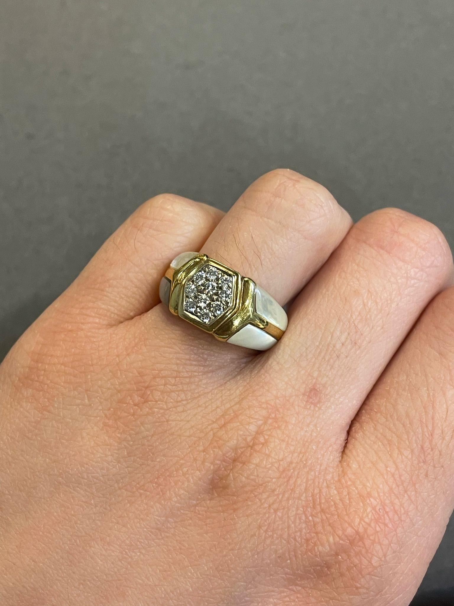 Mother of Pearl and Diamond Ring 

Yellow gold ring featuring four mother-of-pearl panels and ten round-cut diamond accents.

Approximate Diamond Weight: 0.60 carats
Ring Size: 6.25
Complimentary resizing 
Metal Type: 18 karat gold