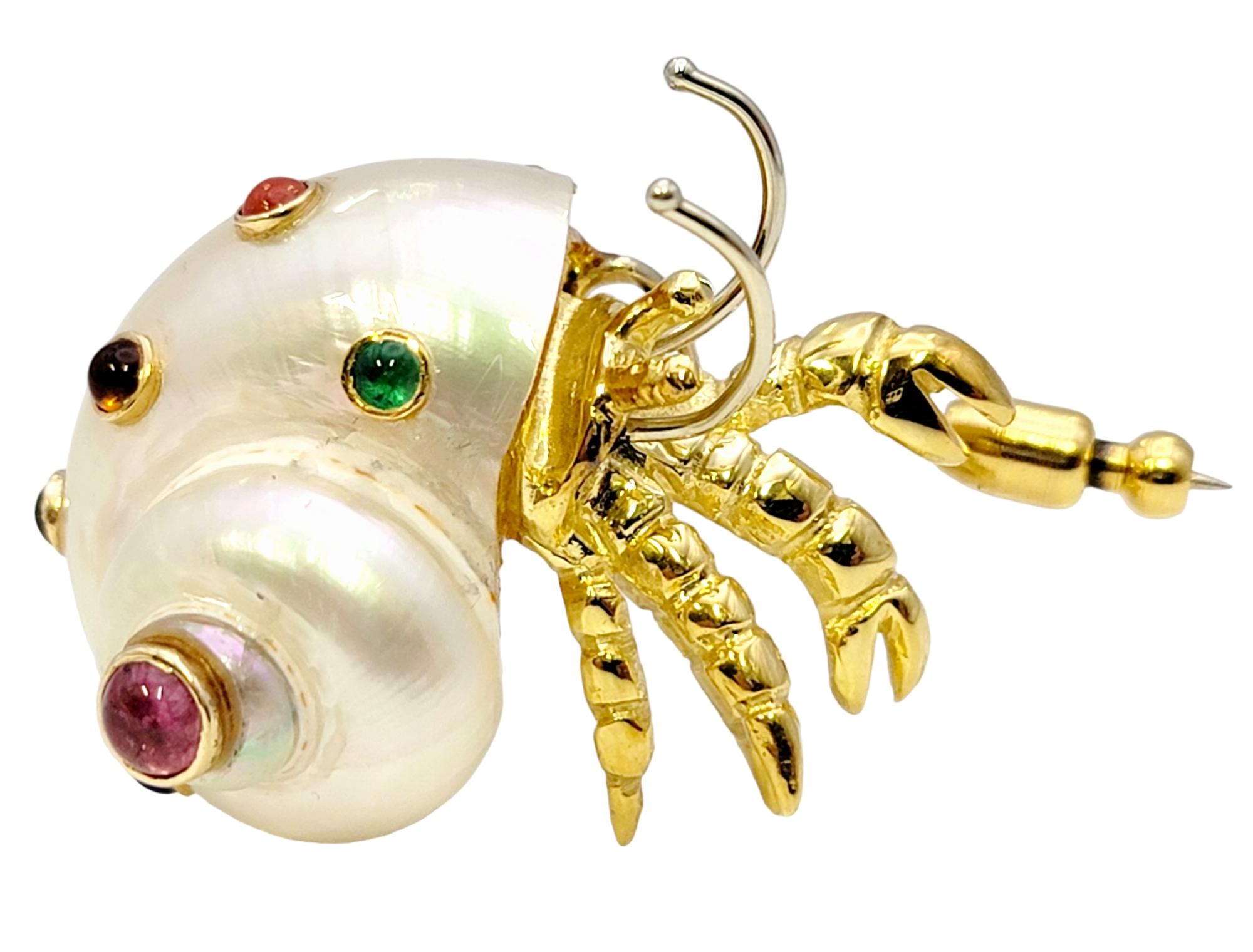 Calling all ocean lovers! This charming little crustacean will remind you of a blissful day at the beach. The modernized Mother of Pearl hermit crab is embellished with assorted colorful natural gemstones, shimmering beautifully in the light and