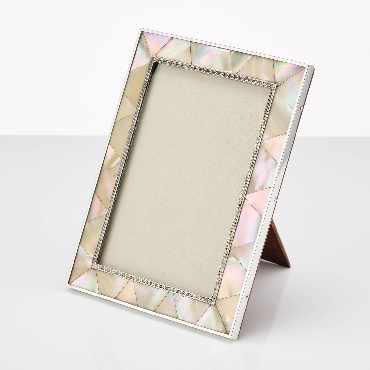 Mother-of-pearl and silver, photograph frame, London, 1923-1924.
This frame is in excellent condition and retains its original oak back
Maker Plante & Bannister.