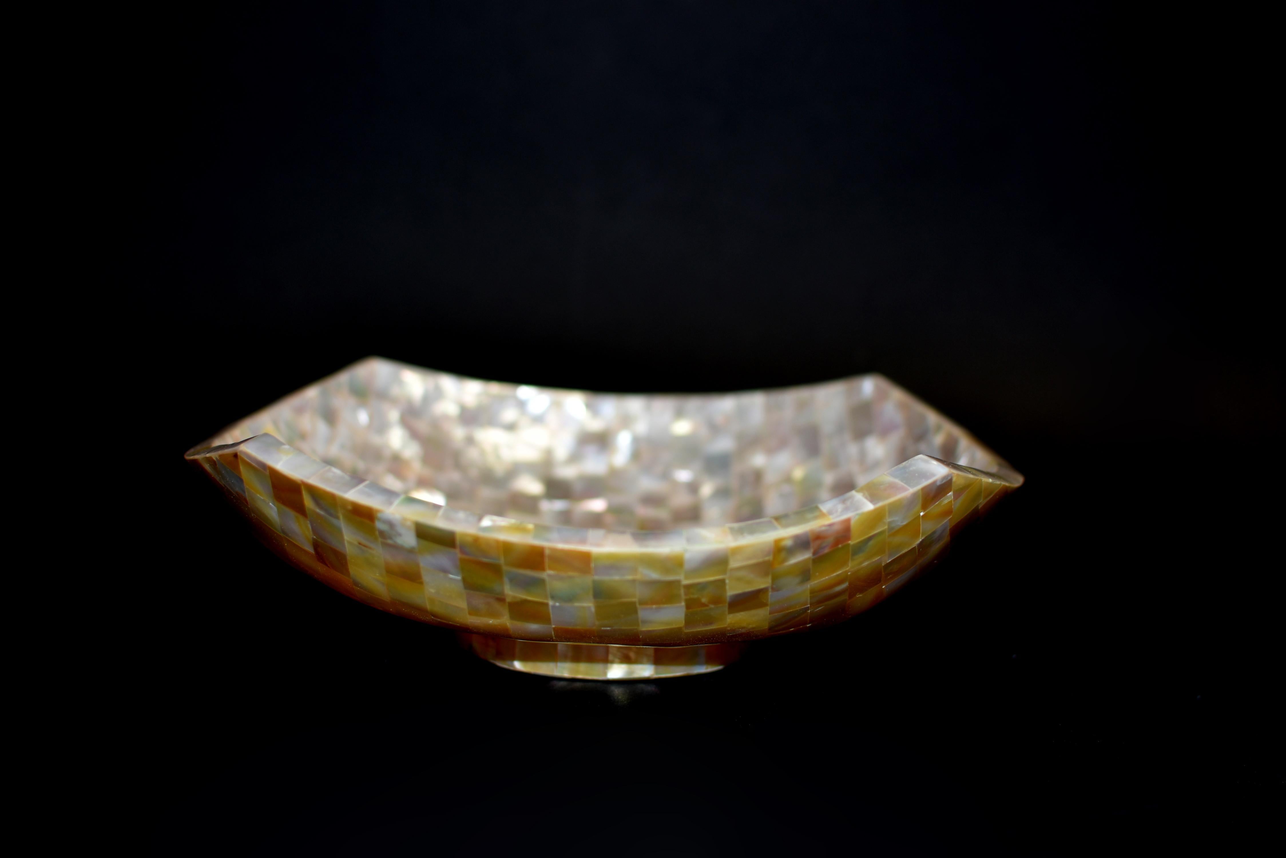 A spectacular mother of pearl bowl, completely hand made by the Indonesian craftsmen. Bowl is meticulously encrusted with mother of pearl and polished to a beautiful, lustrous shine. Perfectly smooth to touch, iridescent inside, out and all around.