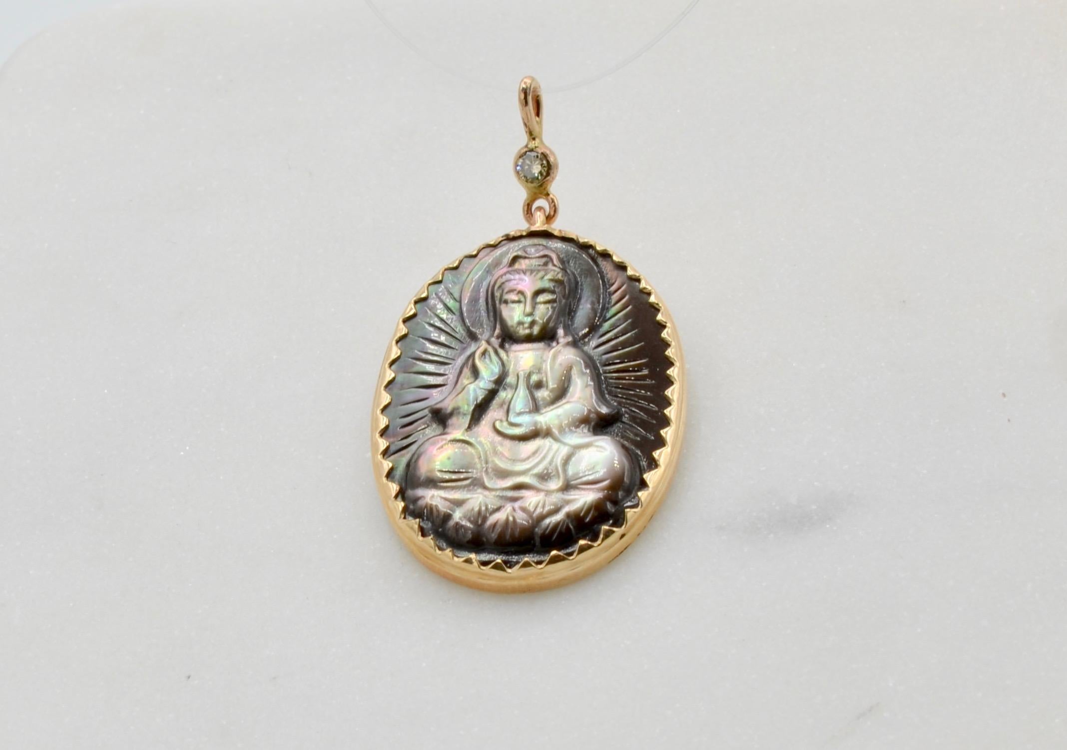 This black Mother of Pearl has hand carving of Buddha set in 14 karat gold with 0.05 carat diamond bale. It is a beautiful pendant that can be worn on a gold chain or as a choker on a black ribbon. The chain in the photo can be purchased separately.