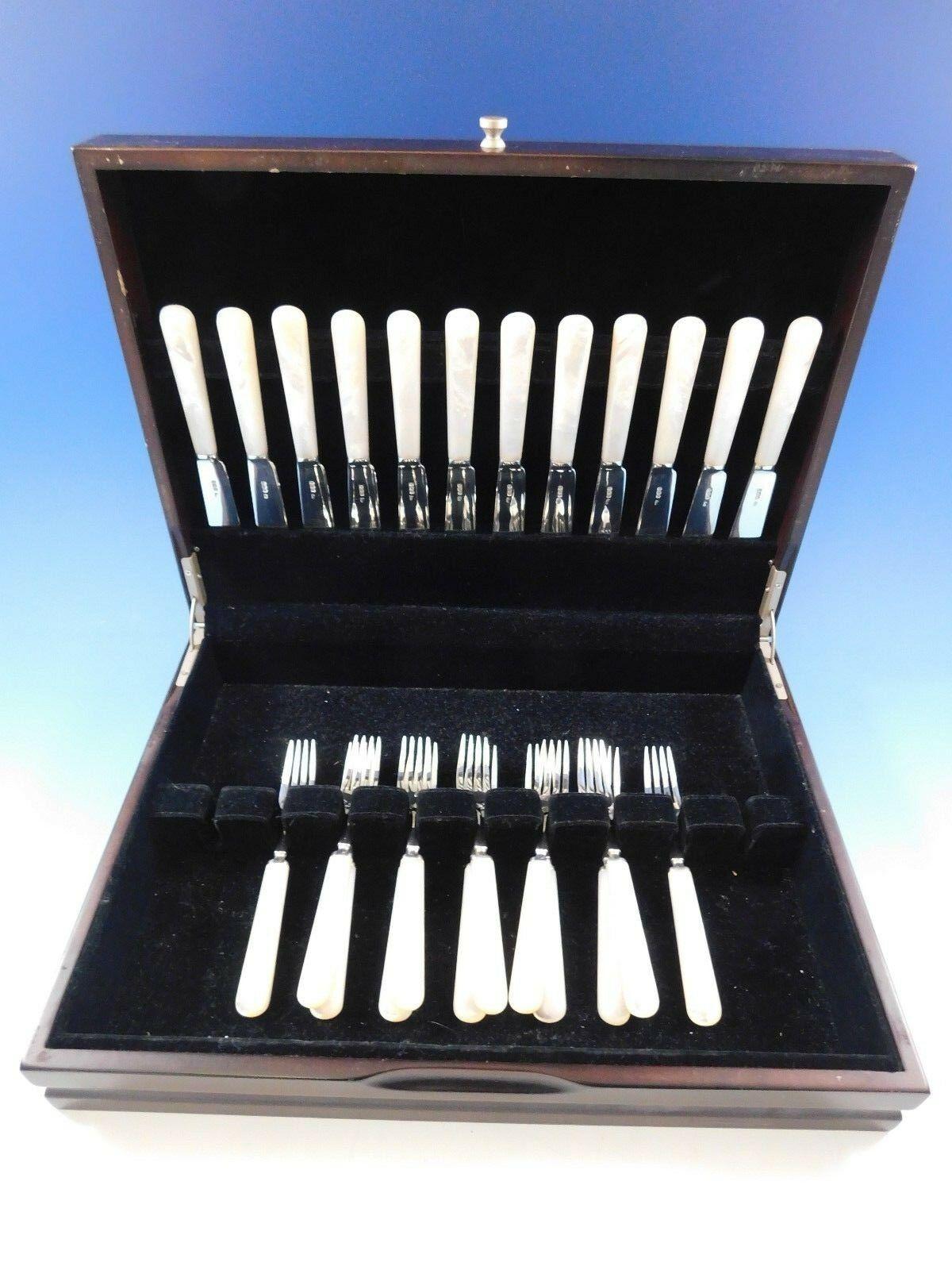 Stunning mother of pearl fish set by Frank Cobb and Co. Ltd English sterling silver fish set, 24 pieces. These pieces feature a mother of pearl handle and sterling silver blades and tines. This set includes:

12 fish knives, 7 3/8