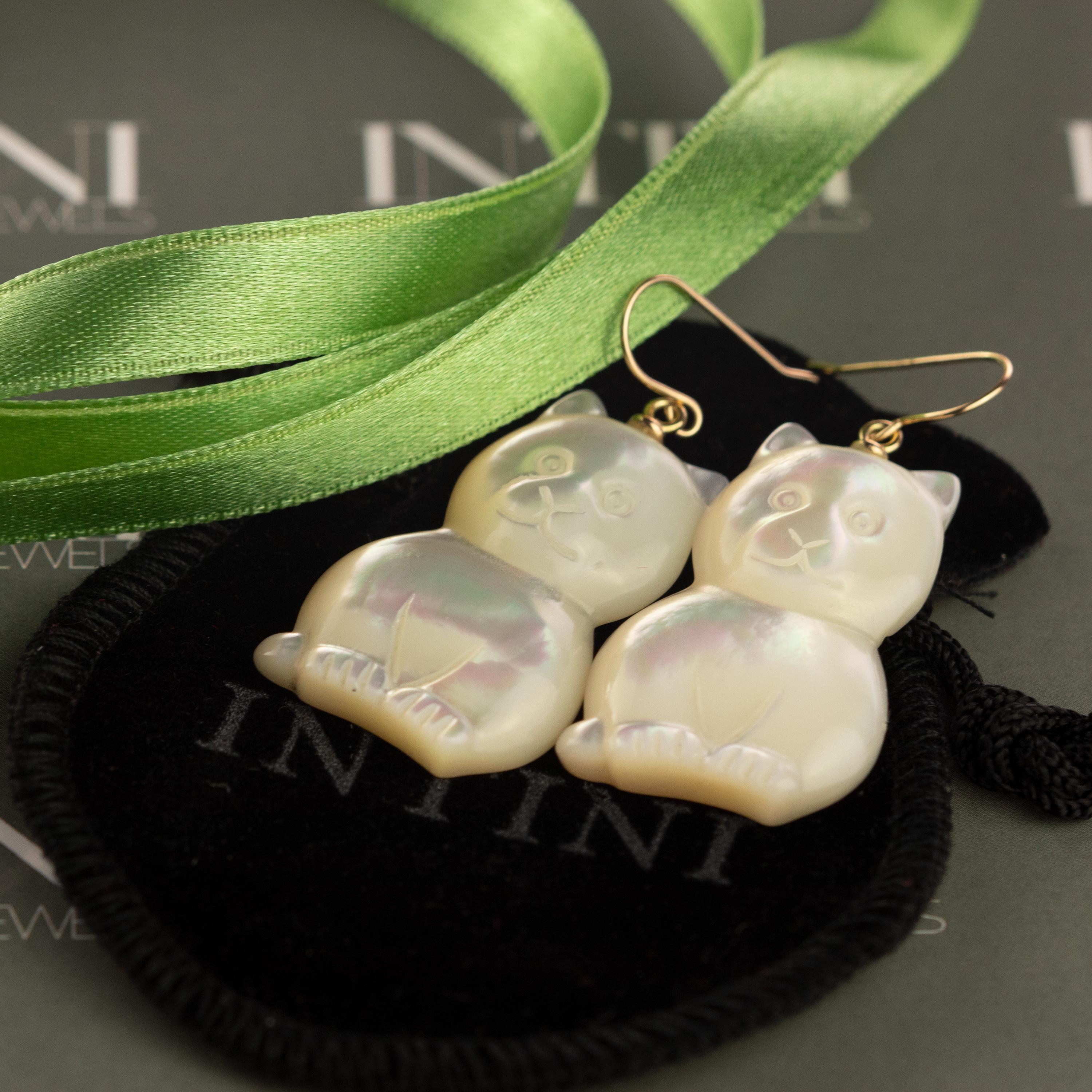 Stunning unique piece. Mother of pearl earrings with an amazing cat, feline or animal shaped form. Marvelous jewel with 18 karat yellow gold setting. Drop, chic and handmade earrings

Mother of Pearl brings the gentle healing power of the sea. It is