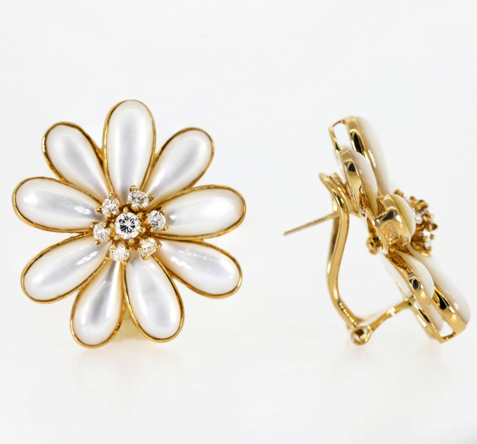 Welcome Spring with these contemporary 18KT yellow gold whimsical Mother of Pearl daisy flower earrings.  The pistil is gifted with a 0.85 carat of Round Brilliant cut Diamonds. The earrings are completed with a straight post and omega back.  They