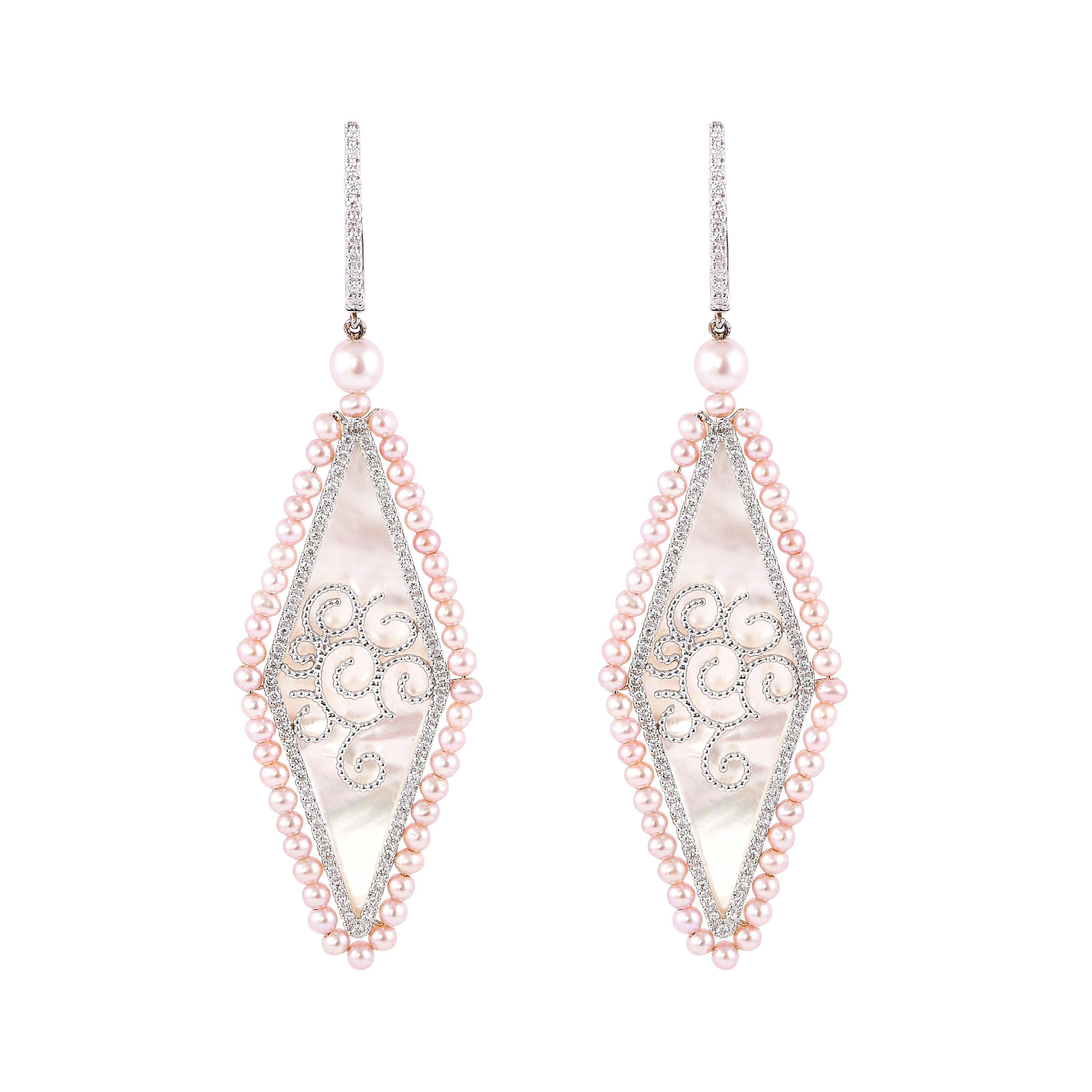 An exclusive collection of designer and unique dangle earrings by Sunita Nahata Fine Design. 

Mother of Pearl Dangle Earring in 18 Karat White Gold.

Mother of Pearl: 8.59 carat, Fancy Shape.
Pink Pearl: 6.45 carat, 2.00 Size, Ball Shape.
Pink