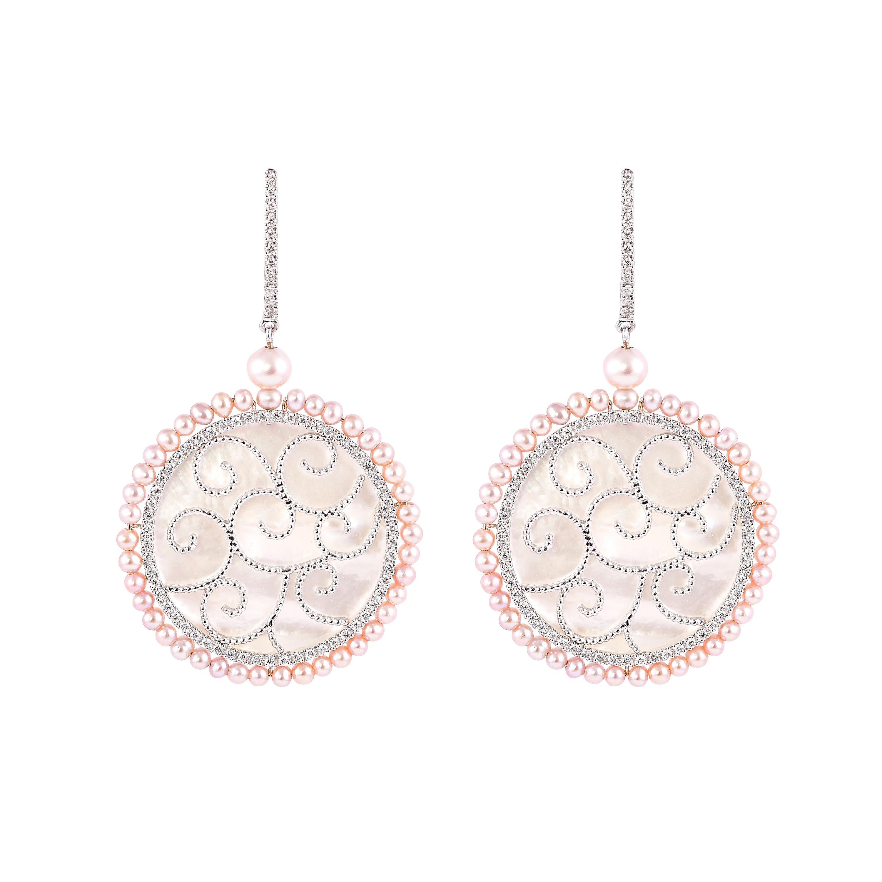 An exclusive collection of designer and unique dangle earrings by Sunita Nahata Fine Design. 

Mother of Pearl Dangle Earring in 18 Karat White Gold.

Mother of Pearl: 13.79 carat, Fancy Shape.
Pink Pearl: 5.49 carat, 2.00 Size, Ball Shape.
Pink