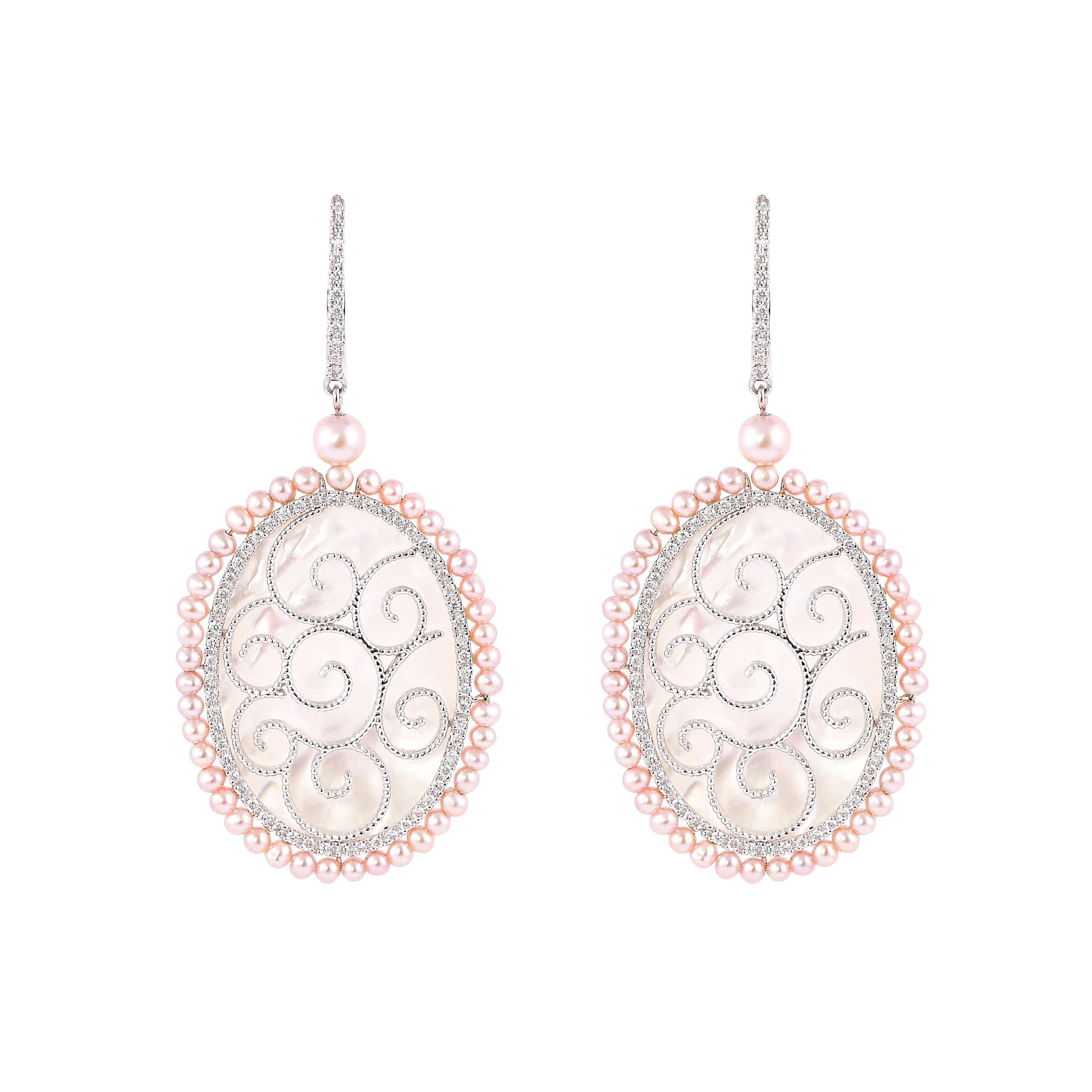An exclusive collection of designer and unique dangle earrings by Sunita Nahata Fine Design. 

Mother of Pearl Dangle Earring in 18 Karat White Gold.

Mother of Pearl: 14.95 carat, Fancy Shape.
Pink Pearl: 5.75 carat, 2.00 Size, Ball Shape.
Pink
