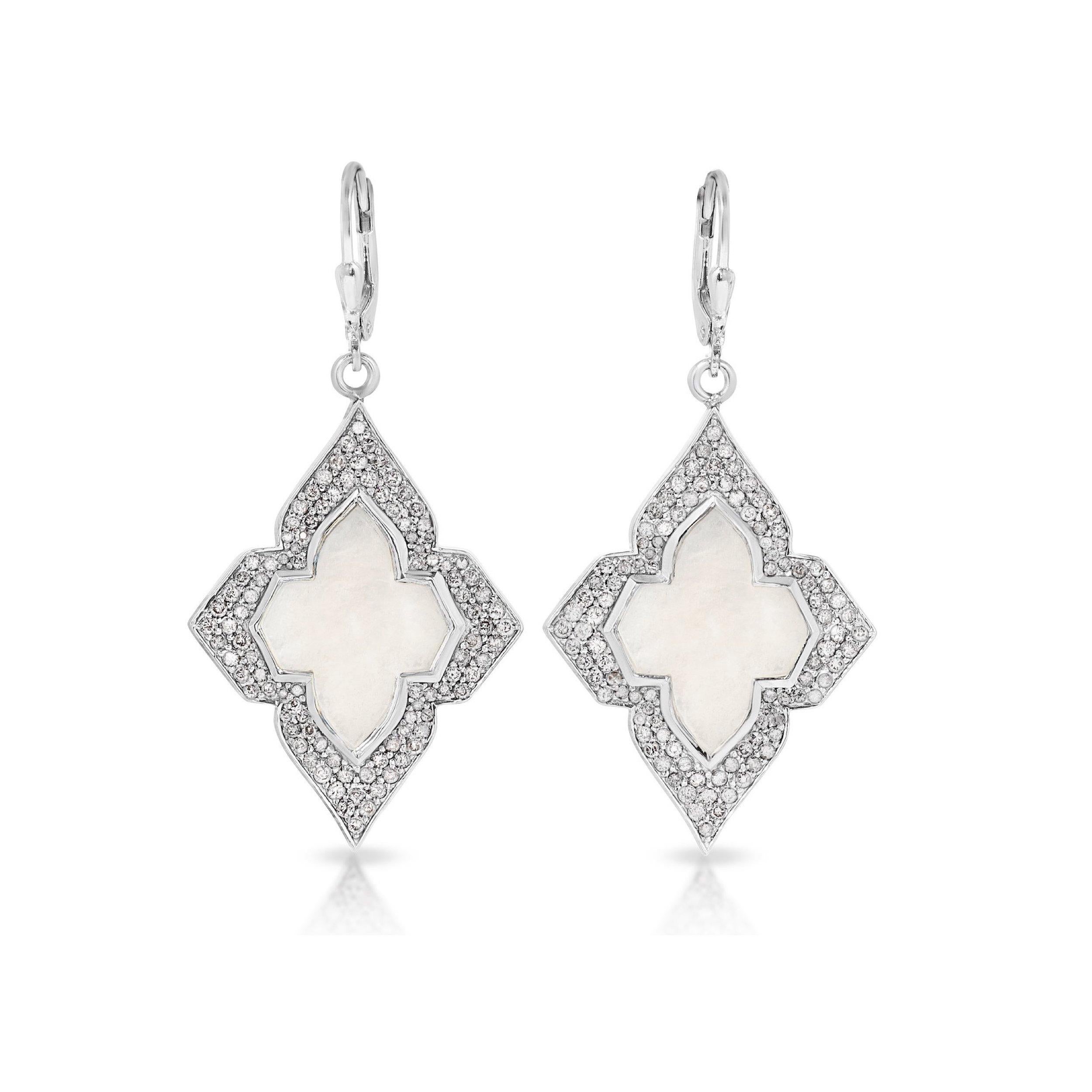 Beautiful drop earrings in a modern interpretation of the iconic Art Deco era in jewelry. These earrings feature milky, luminescent Mother of Pearl centers encased with sparkling White Diamonds set in fabulous earrings of Silver. These beautiful