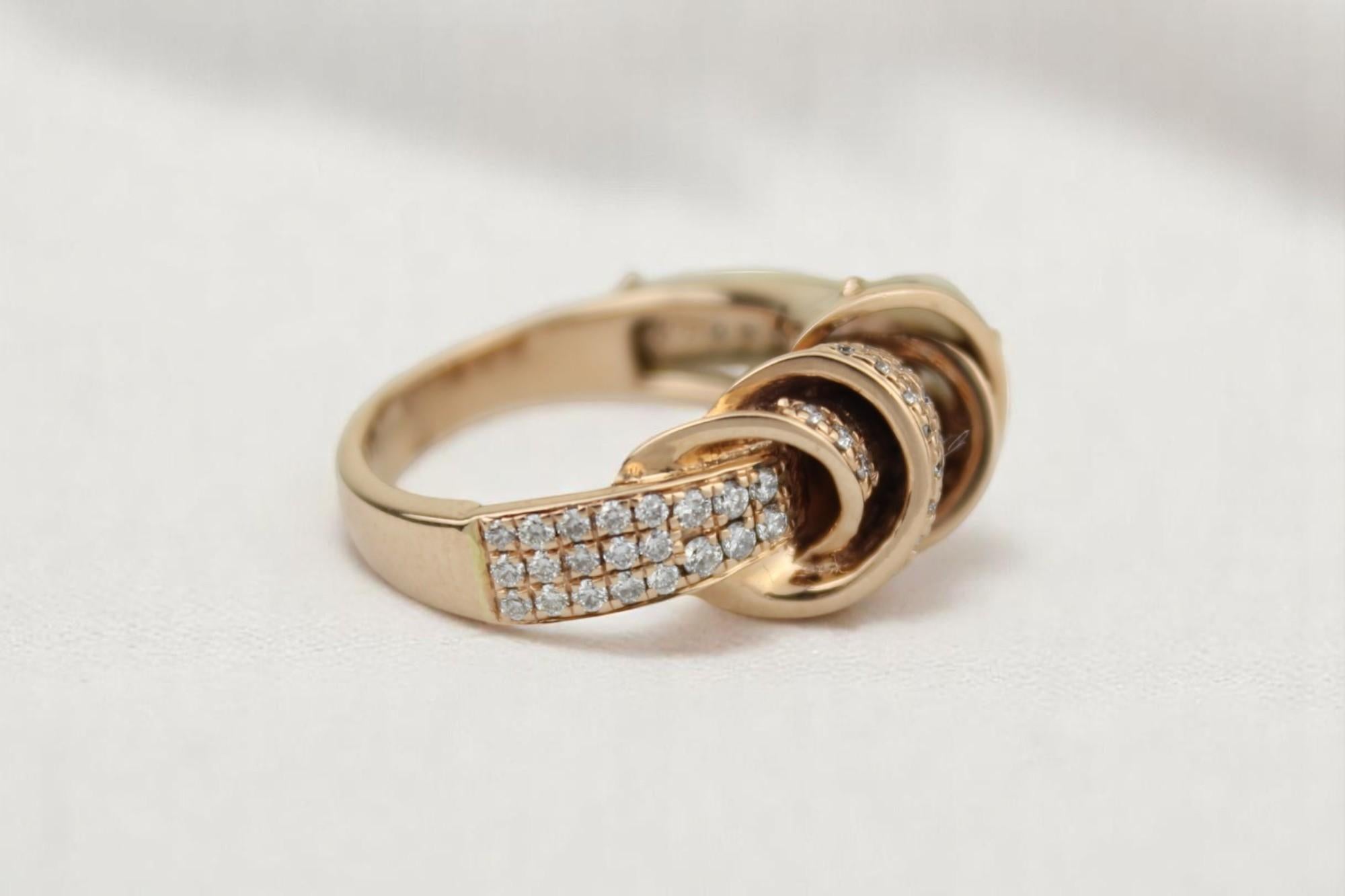 All our jewelry pieces are certified by a third-party laboratory such as IGI, HRD, IDGL, GIN, or SGL.

Crafted in 14k solid gold with interlocking swirl elements, this artistic ring is set with natural diamonds in a fluid link-inspired form. The