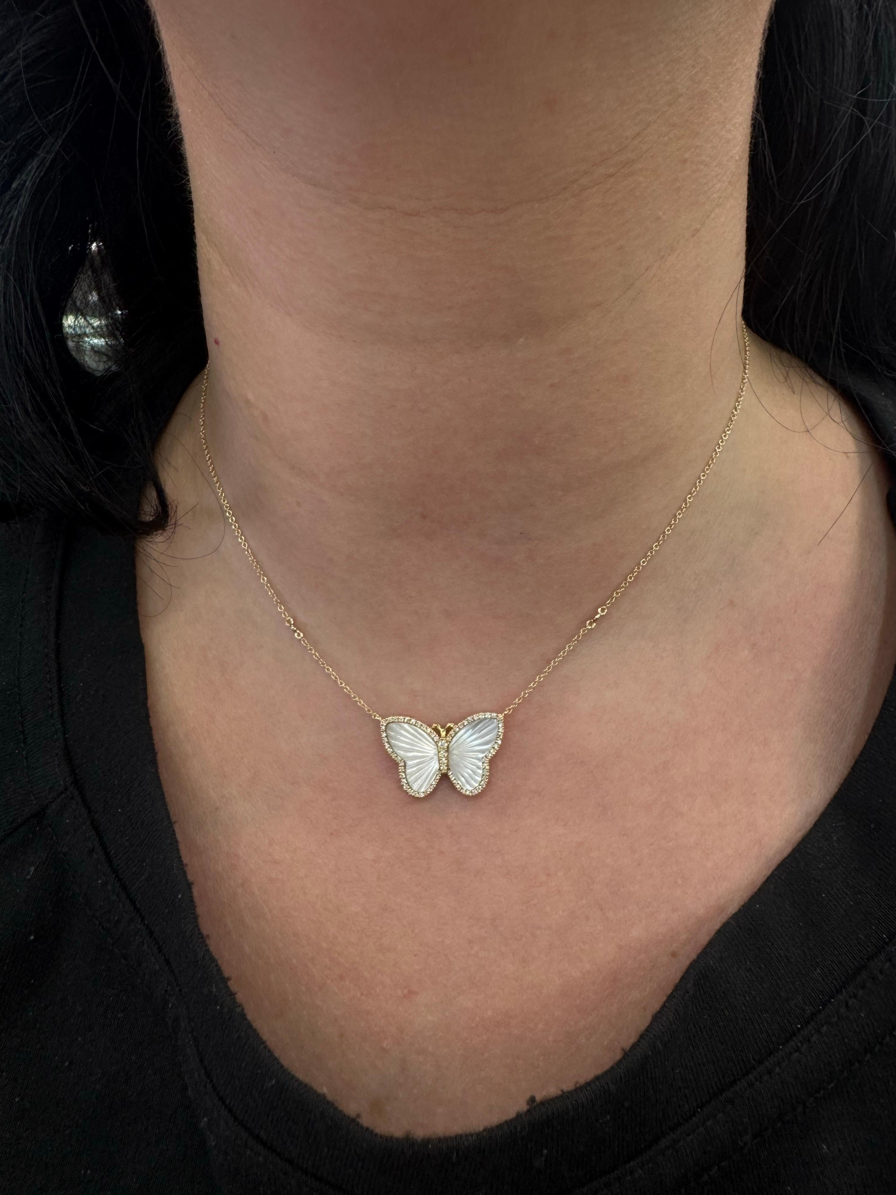 Questa elegante collana con ciondolo a forma di farfalla è splendidamente realizzata in oro giallo 14K e presenta ali di madreperla intricatamente intagliate per un totale di 2,57 carati. La farfalla è circondata da un delicato alone di 68 diamanti