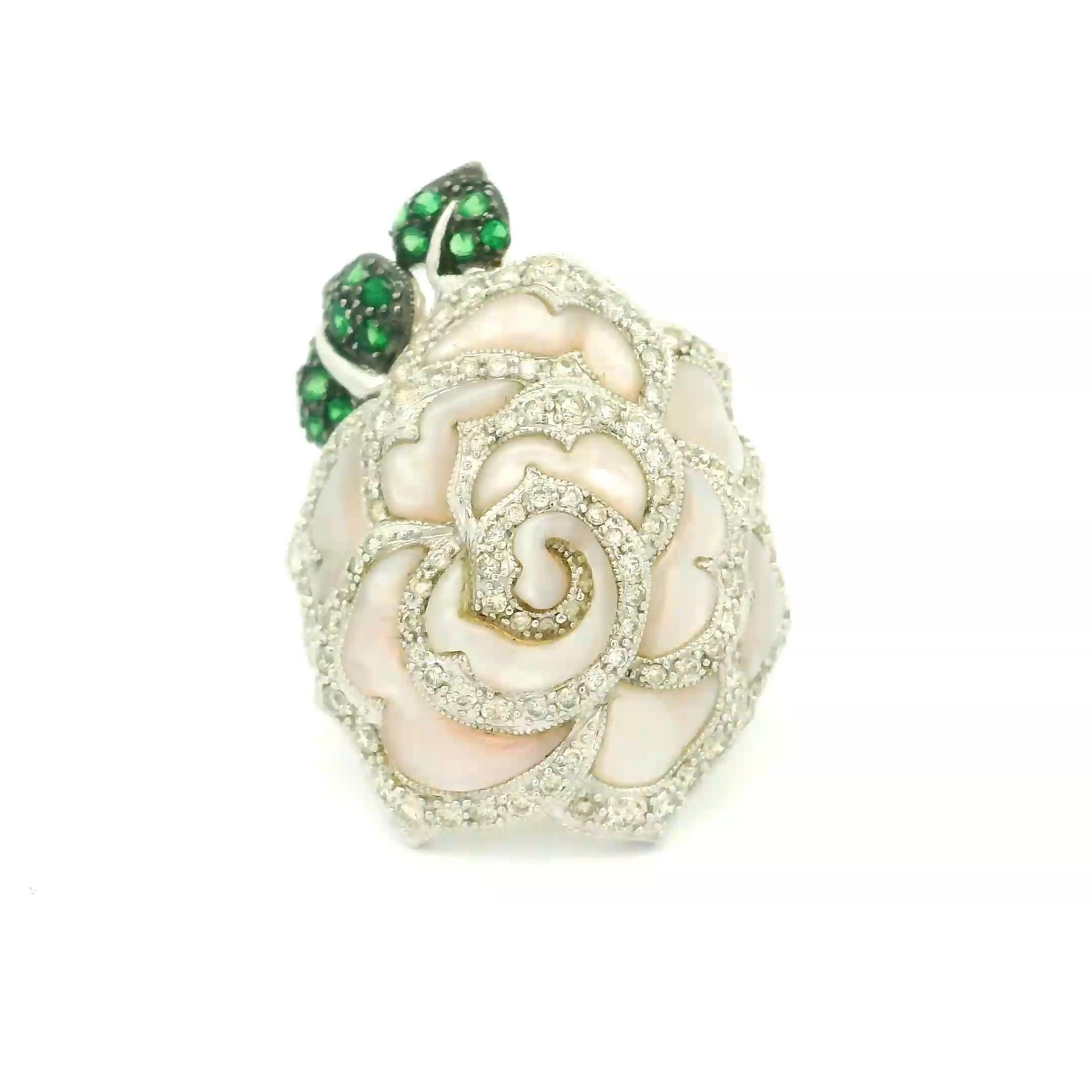 A lovely rose ready to be worn This beautiful ring features lustrous Mother-of-Pearl formed as rose petals along with 1.11 carats of round brilliant-cut diamonds which lines the flower petals. Additionally, 0.32 carats of intense green Tsavorite are