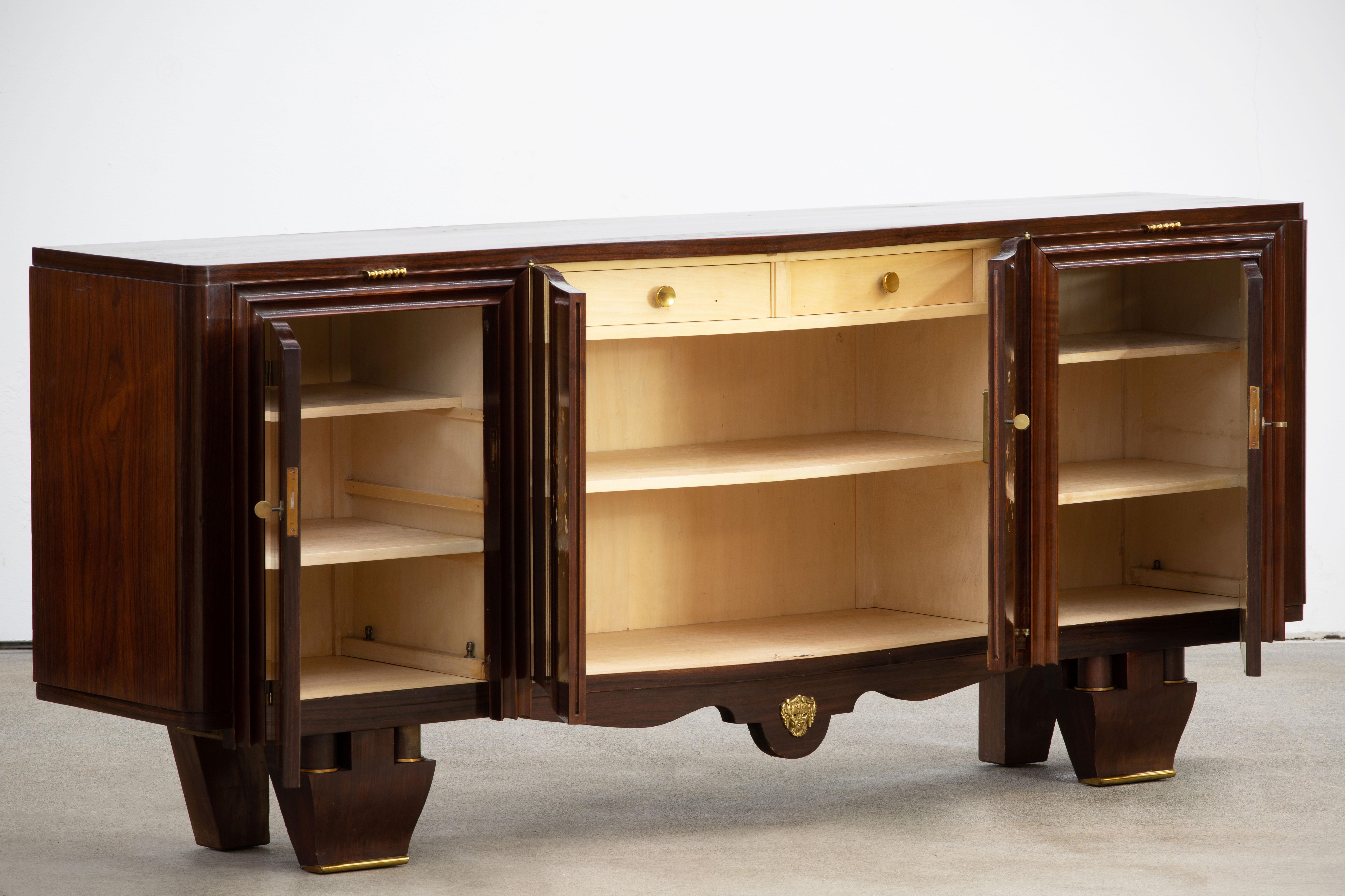 French Art Deco sideboard, credenza. The sideboard features stunning Macassar ebony wood grain with a thin decorative mother of pearl inlay design with butterflies and flowers. The inside is also a piece of art with wooden pieces and mother of pearl