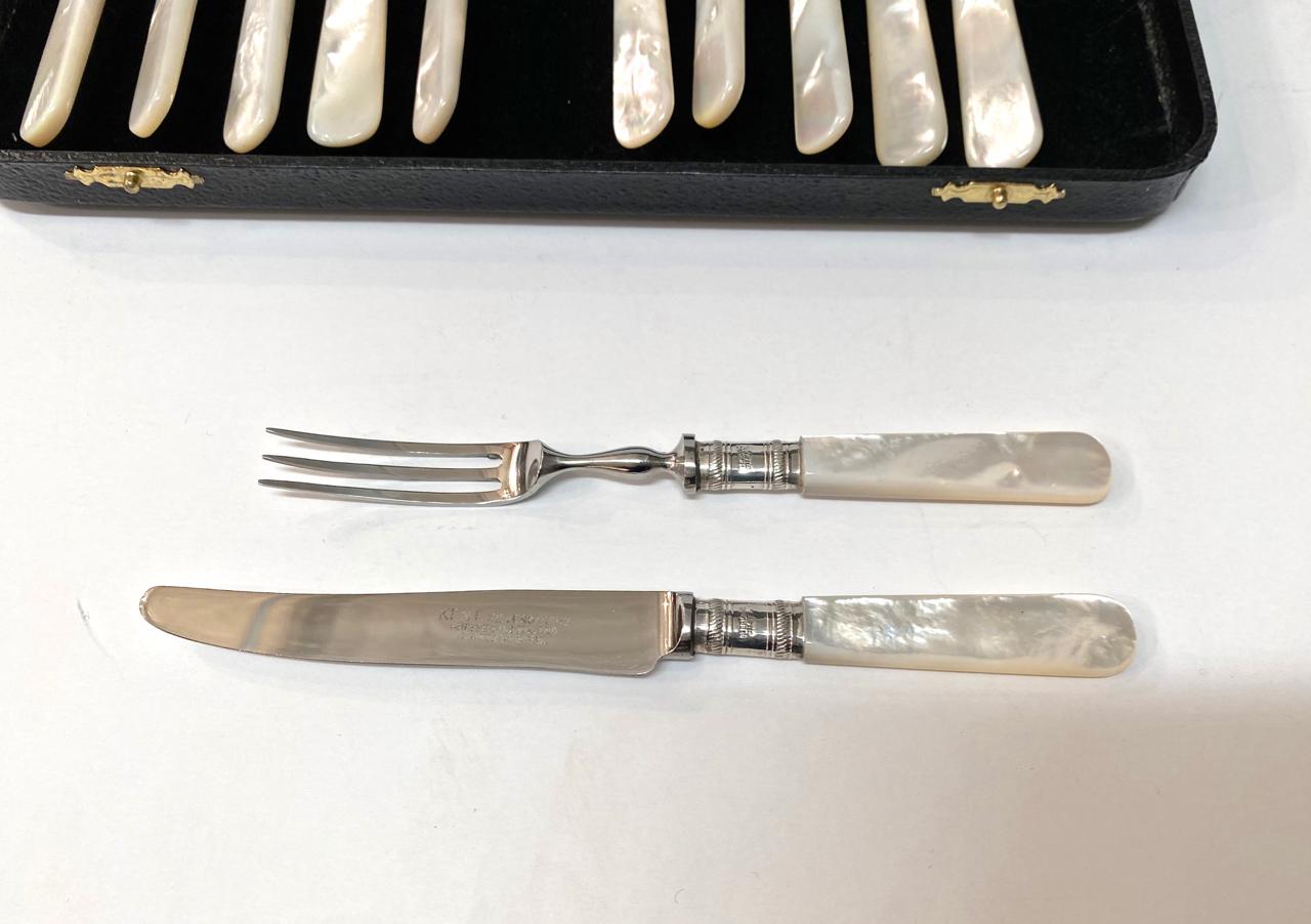 This is an iconic example of an early 20th century mother of pearl fruit or dessert service. Consisting of 6 forks and knives. All 12 elements are in very good overall condition. The original box is also in good condition. This would make a