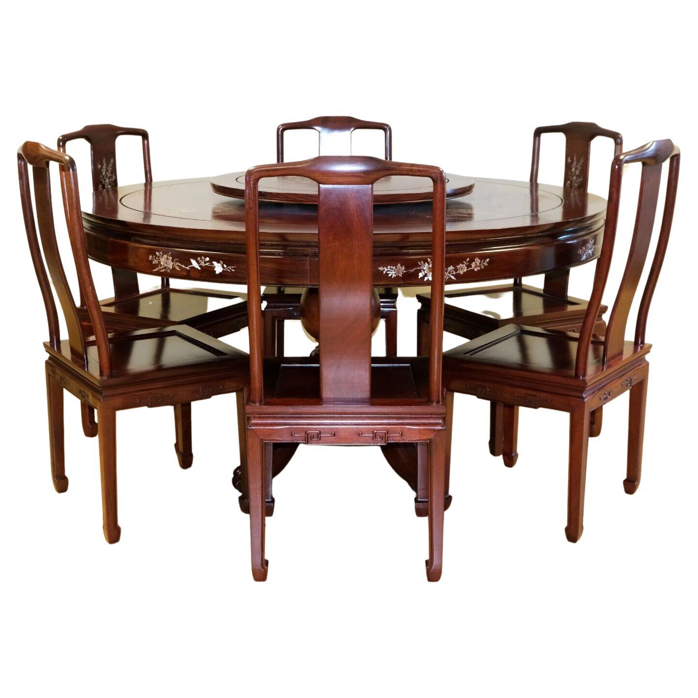 We are delighted to offer for sale this stunning rosewood Chinese round dining table with six chairs and lazy Susan. 

This exquisite and delightful set offers you a good sized table, lazy Susan and six dining chairs. For start, the table (non