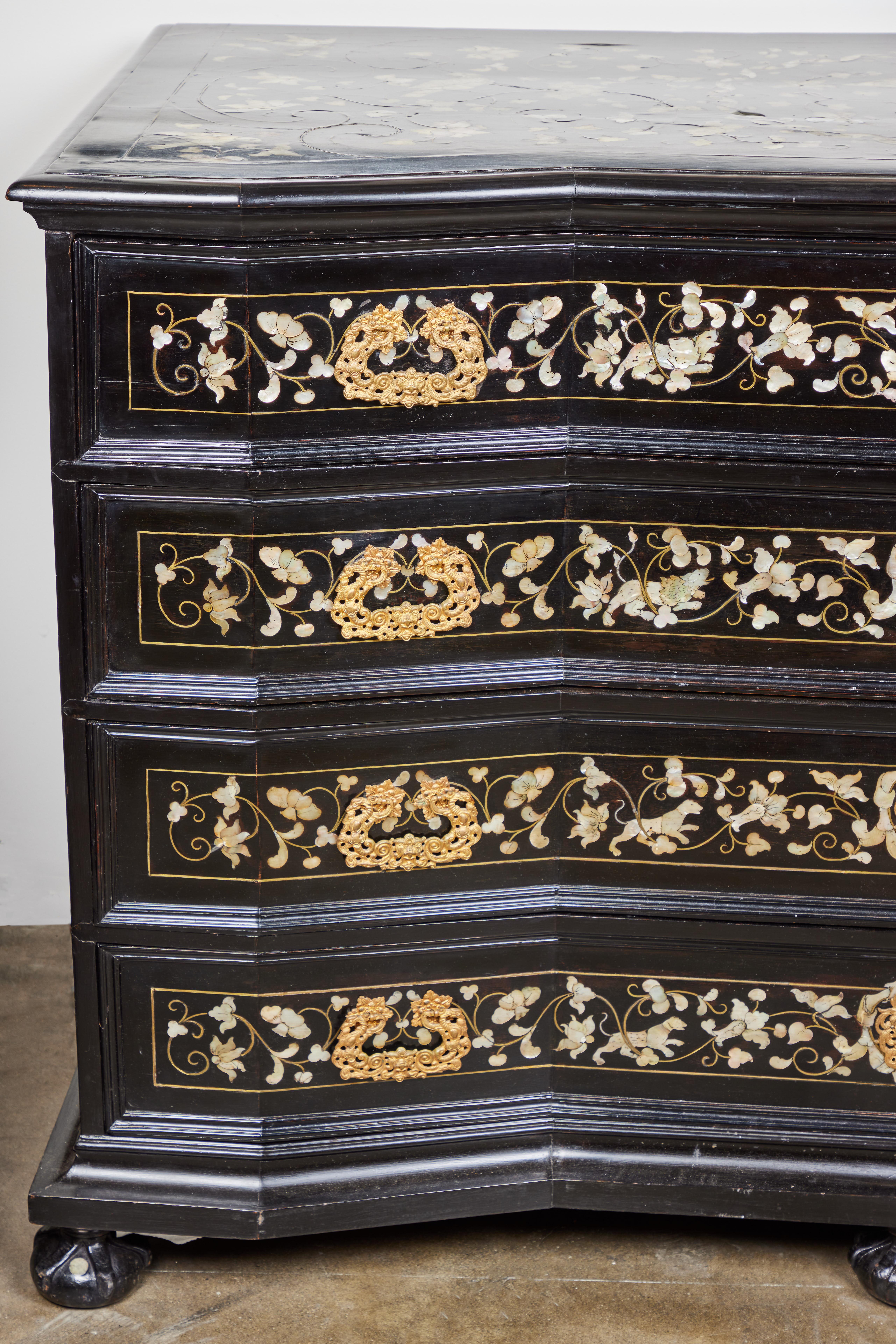 A rare and exceptional Tuscan, ebonized 4 drawer commode inlaid with gilded bronze and mother of pearl. Decorated with a motif of flowers, birds and dogs at play. Original hand chased elaborate gilt bronze handles and locks with center shields. The