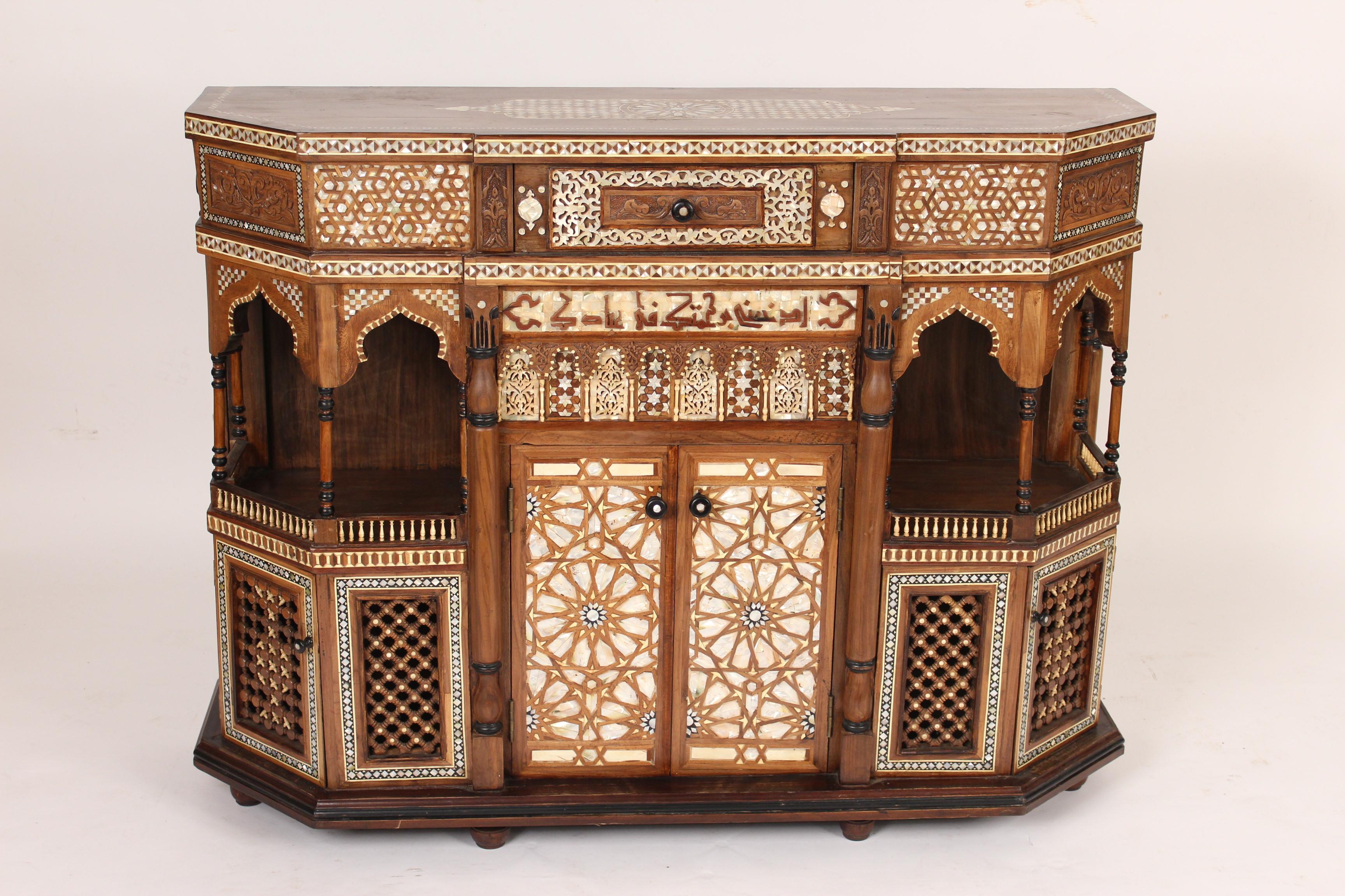 Mother of pearl inlaid and bone Moroccan style cabinet, made in the middle east, early 21st century. The overall dimensions are, height 38.75