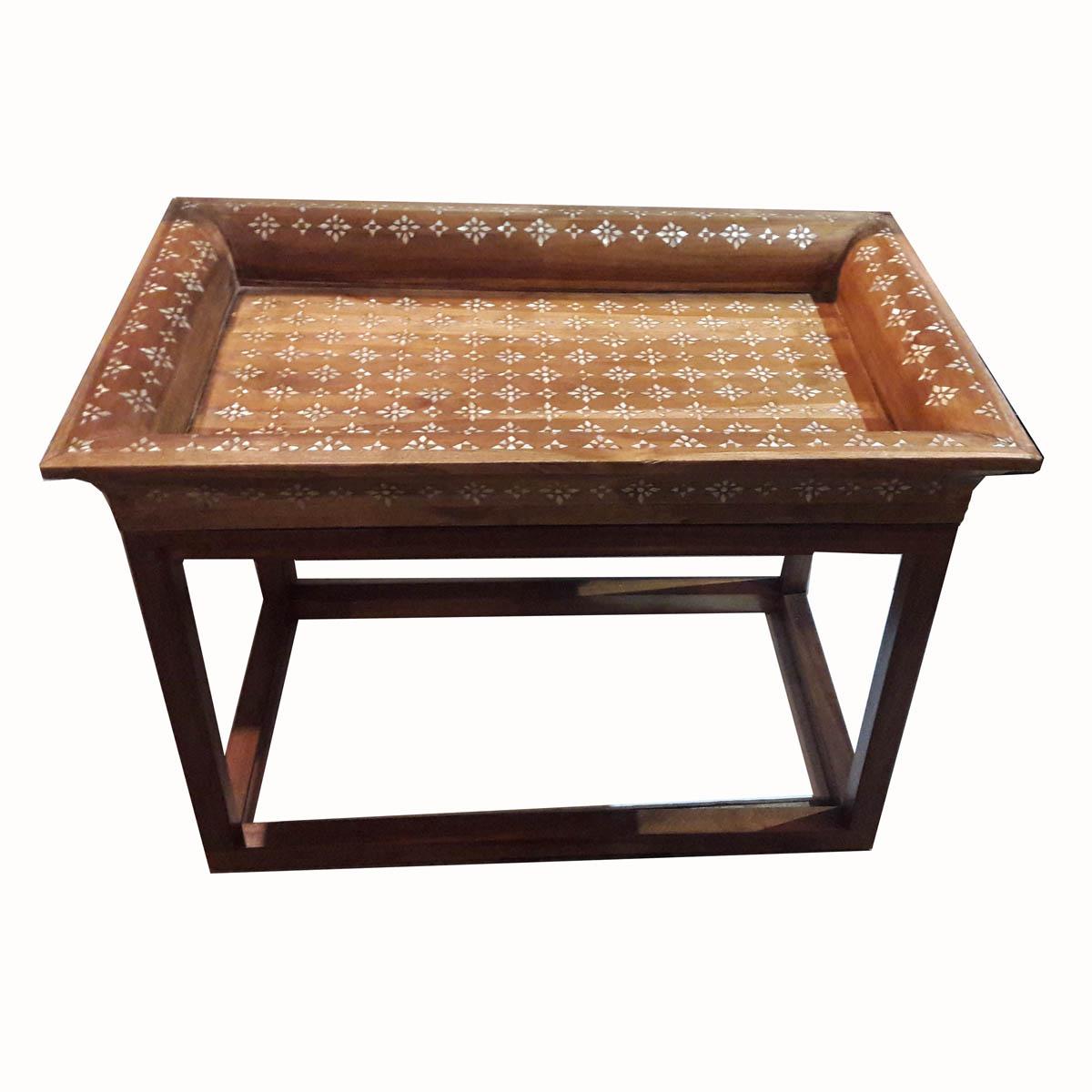 A contemporary coffee table, with a vintage tray inlaid in mother-of-pearl as the top and a wooden stretcher base. This original intervention turned a beautiful vintage tray into a singular, practical side or end table.
   