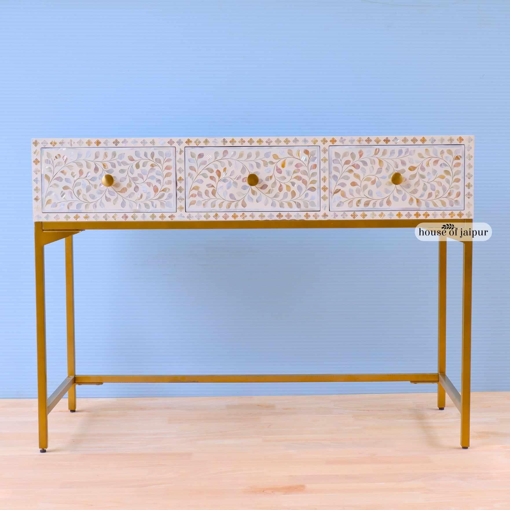 A stunning blend of craftsmanship and contemporary elegance, this Mother of Pearl Inlay Console Table is designed to bring luminosity and artisanal beauty into any room. Featuring an intricate floral vine inlay pattern, each MOP tile is individually