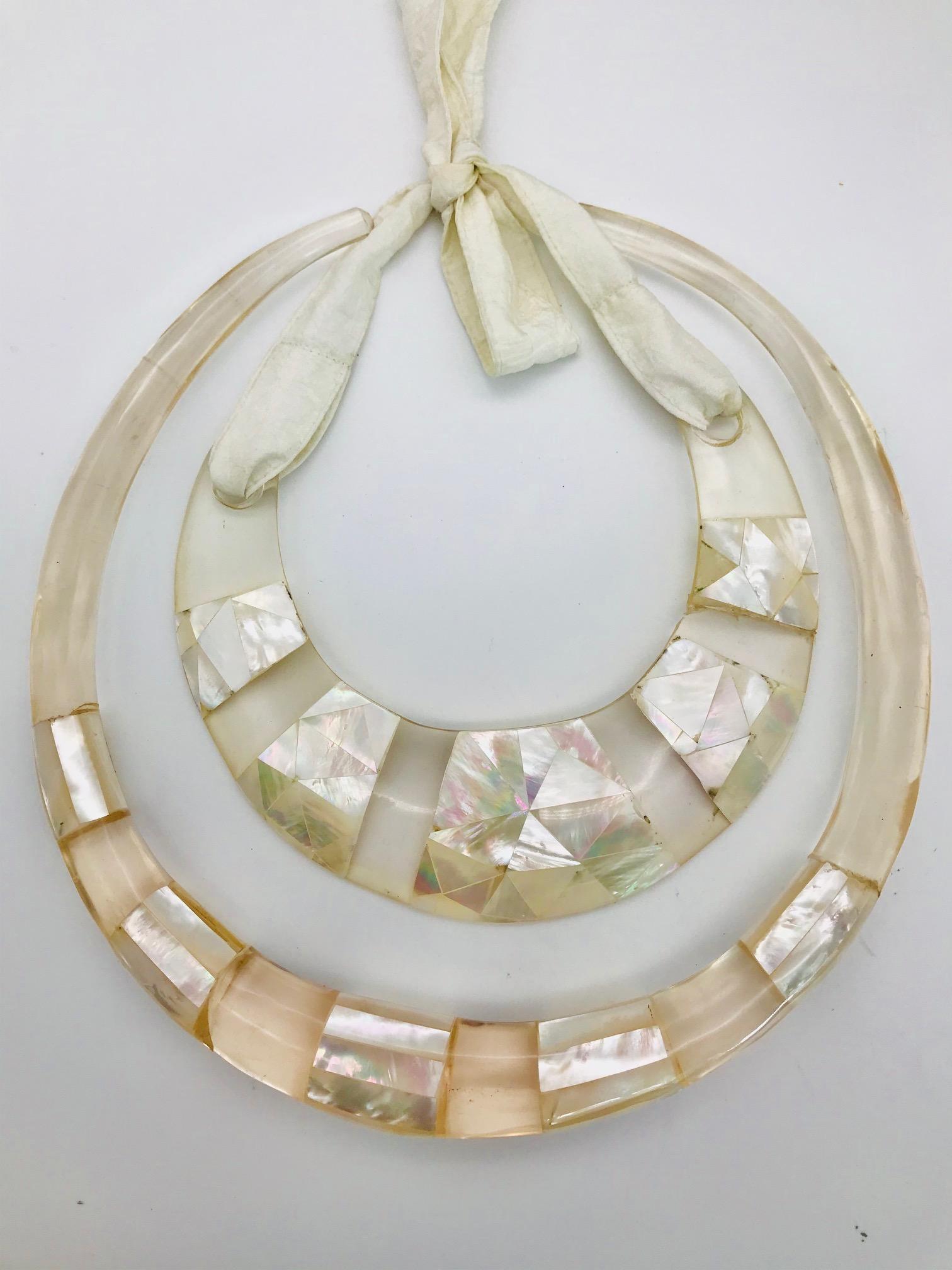 The 2 white Mother of Pearl Statement Necklaces are made  from eco -luxe Materials . Iridescent white mother of pearl and Lucite are a very unique and  creative combination. The design was created in collaboration with my daughter Gaella  Gottwald,