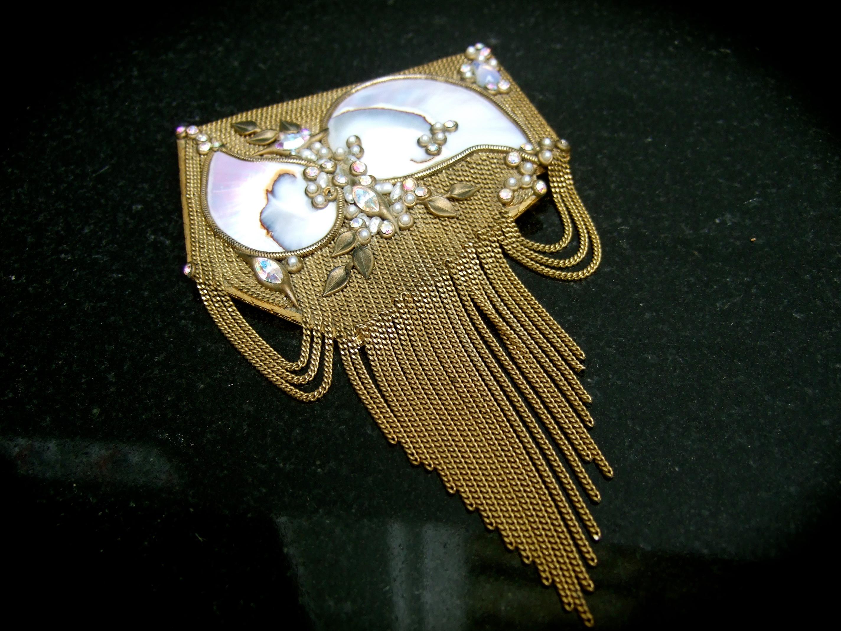 Exquisite mother of pearl massive crystal jeweled gilt metal fringe tassel brooch designed by Marena
The opulent huge scale artisan brooch is adorned with a pair of large polished mother of pearl 
organic shaped tiles

The mother of pearl tiles are
