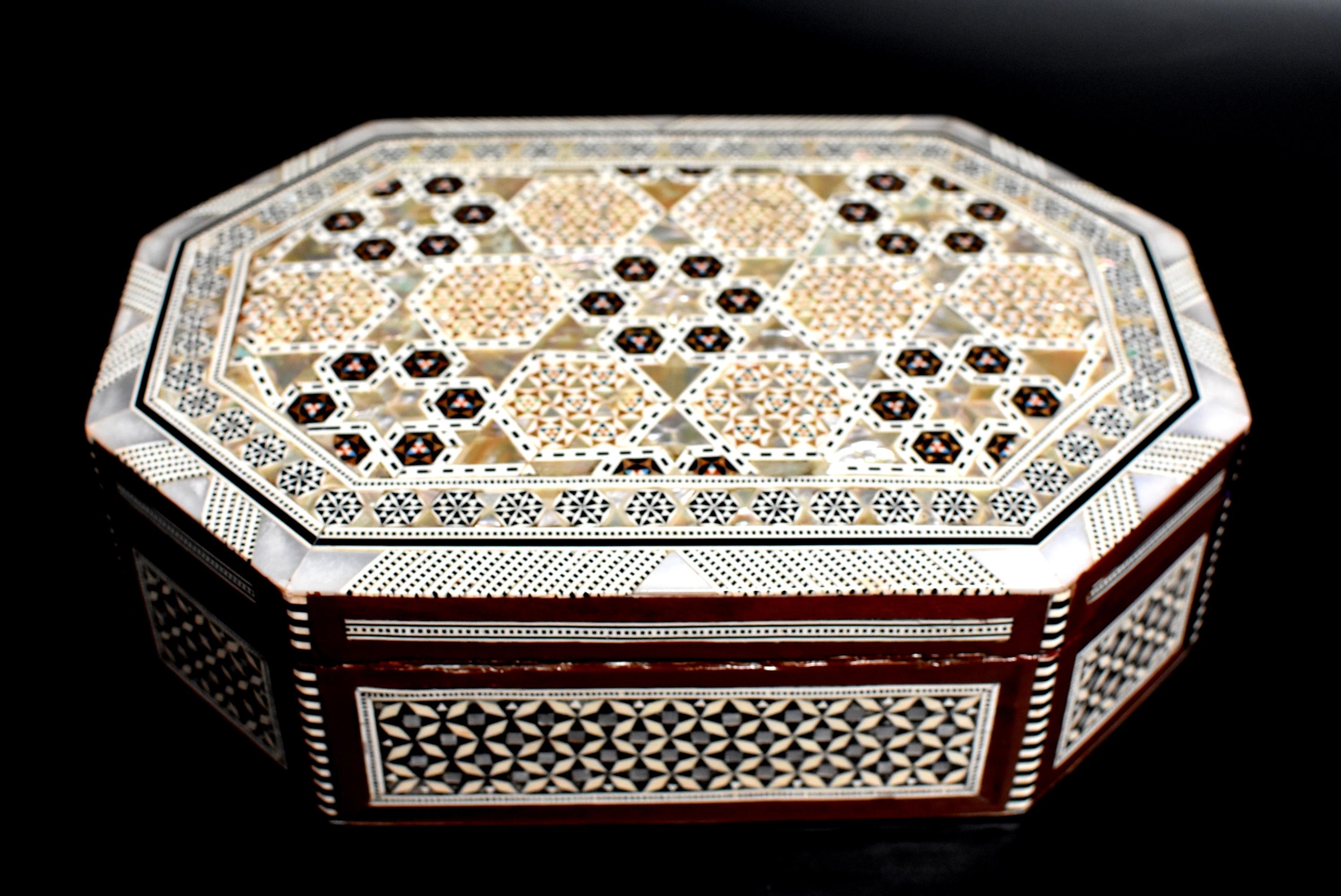 The craftsmanship on this beautiful piece is amazing. The wood box is entirely encrusted in genuine mother of pearl. The intricate pattern and fine precision makes it a true work of art. Lined with felt. Handmade.