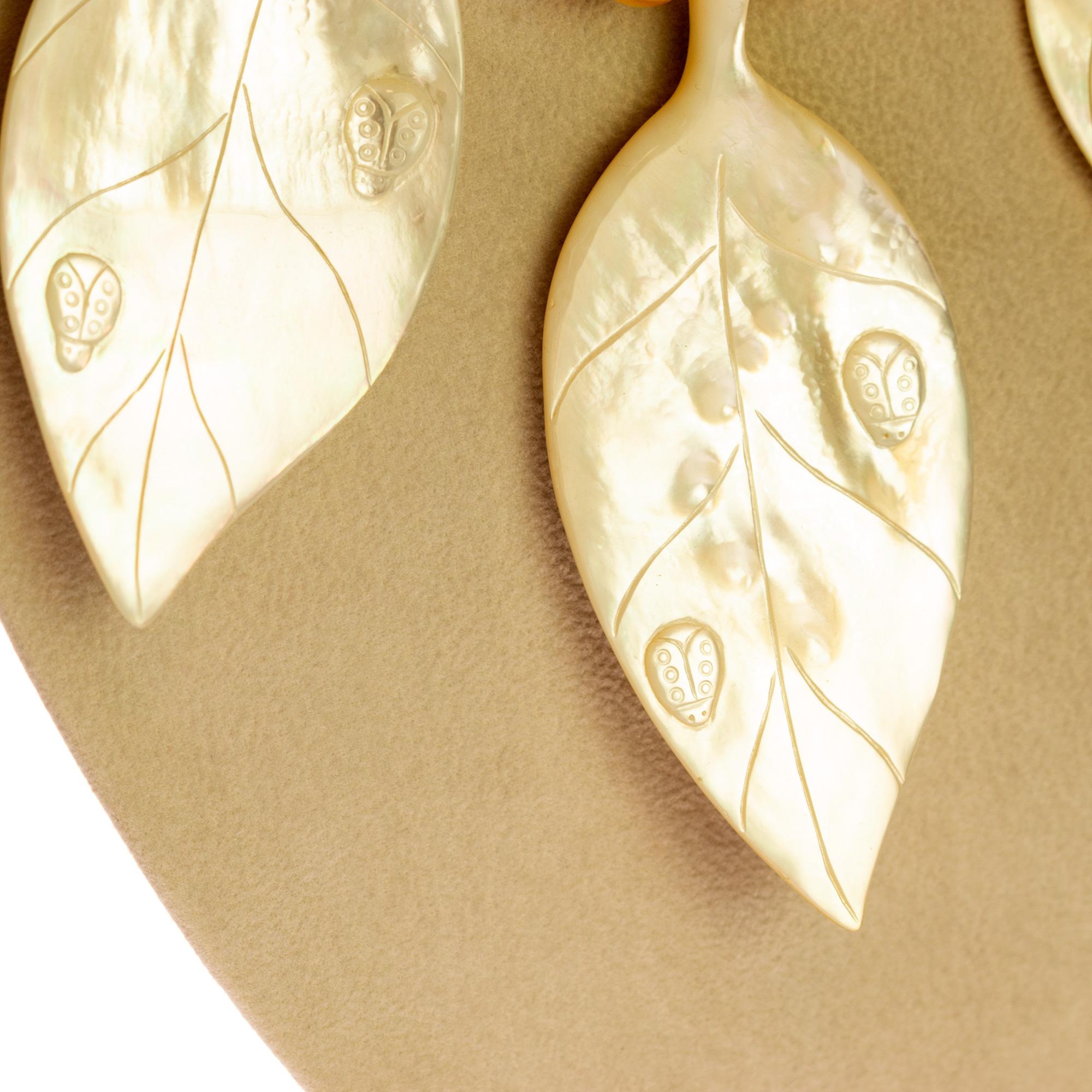 Le splendide madreperle intagliate su una collana colorata creano un eccezionale design Made in Italy.

- Chiusura a moschettone in argento Sterling 925
- Foglie di madreperla 9,5 x 4,5 cm
- Quarzo fumé sfaccettato di 1,2 cm di diametro
- Rondelle