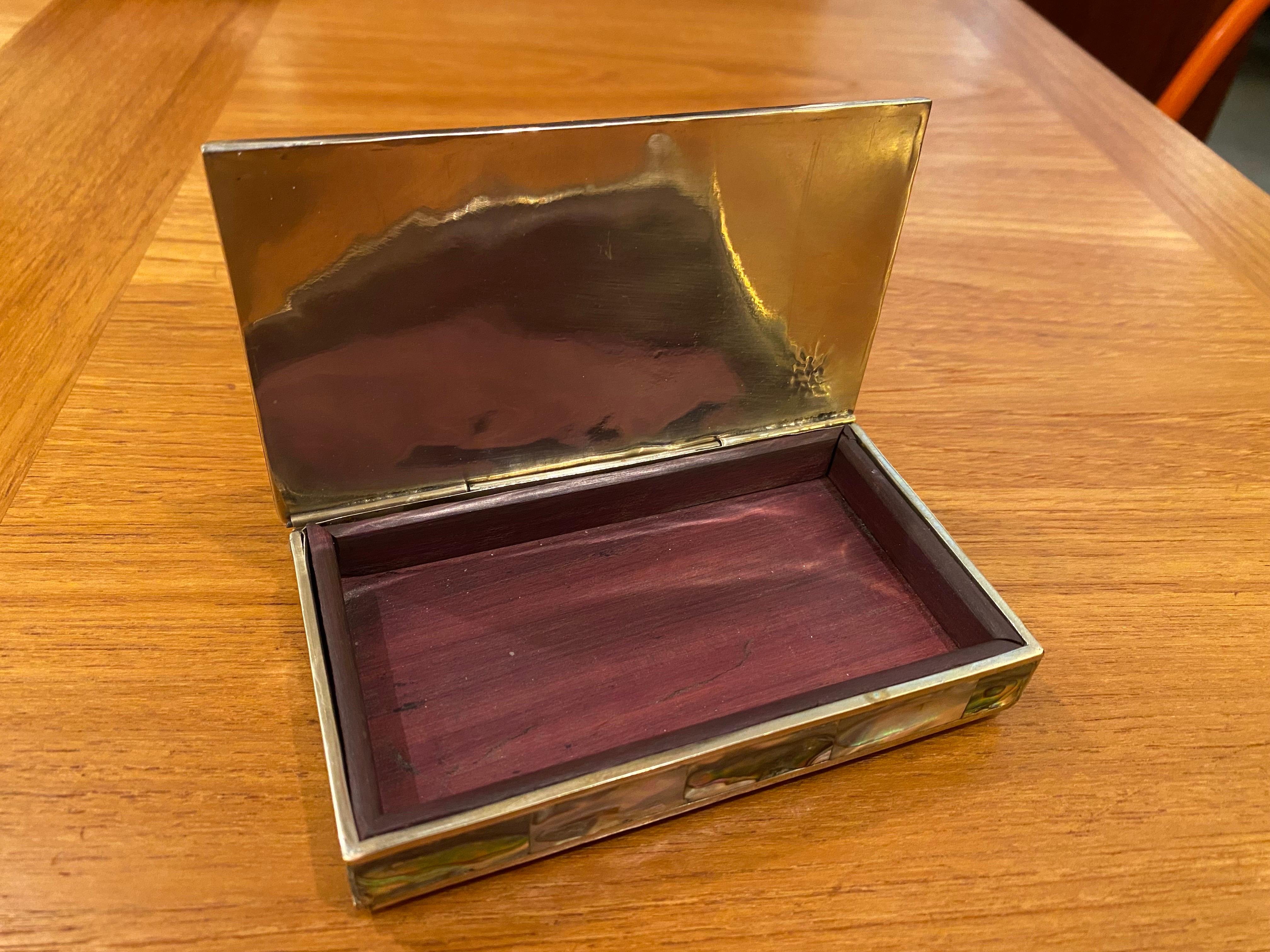 Mexican silver box with Mother-of-Pearl Inlay. Lid opens to a wood lined interior. Very nicely done and a really beautiful object!