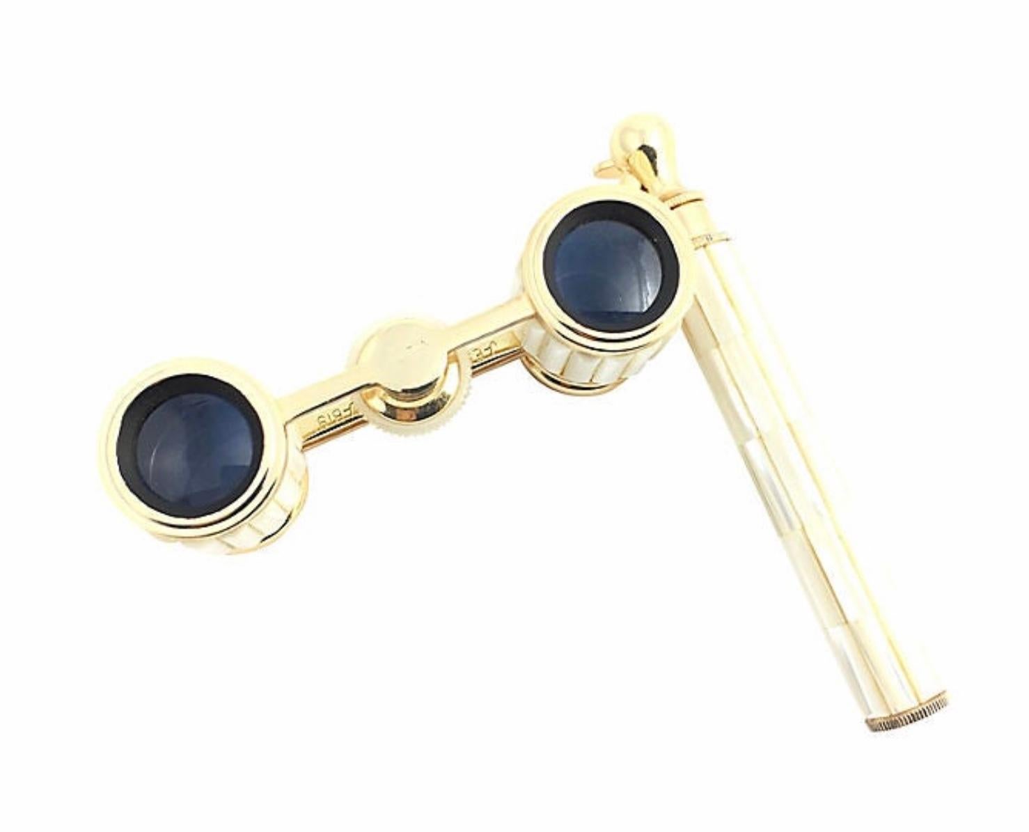 Mother of pearl opera glasses by Mignon in excellent condition. The body of the glasses as well as the telescopic handle are inlaid with real mother of pearl pieces adorned with gold accents. The magnification is 2.5X. Hand-held with “lock in place”
