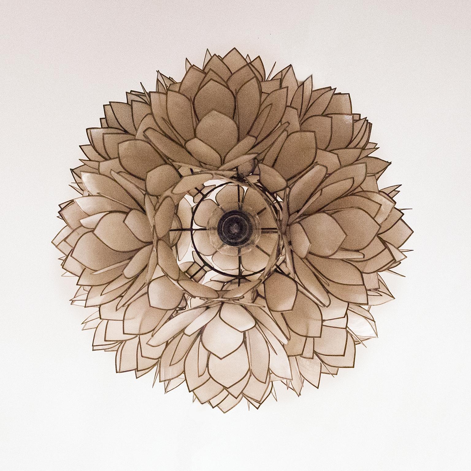 Decorative and look stylish flower Mother of Pearl ceiling lamp. 1970s ball shaped table lamp composed of groupings of thin, individually metal edged, mother of pearl leaves. The leaves form clusters of abstract flowers. The lamp lends it self easy