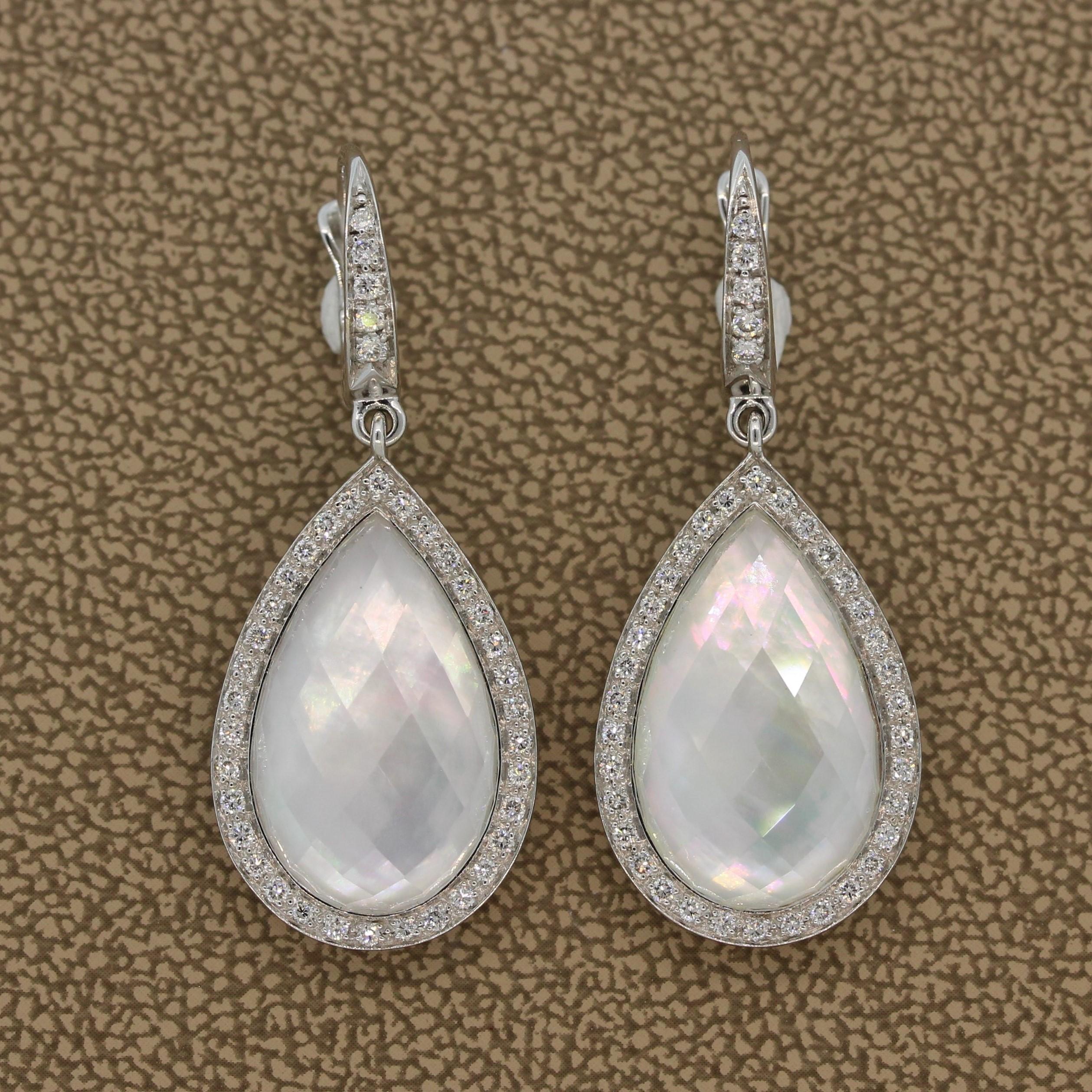 These bright and vibrant drop earrings feature 13.76 carats of  quartz with 4.49 carats of mother of pearl underneath the checkerboard quartz which adds rainbow hues to the gemstones. The pear shape quartz and mother of pearl are haloed by 0.54