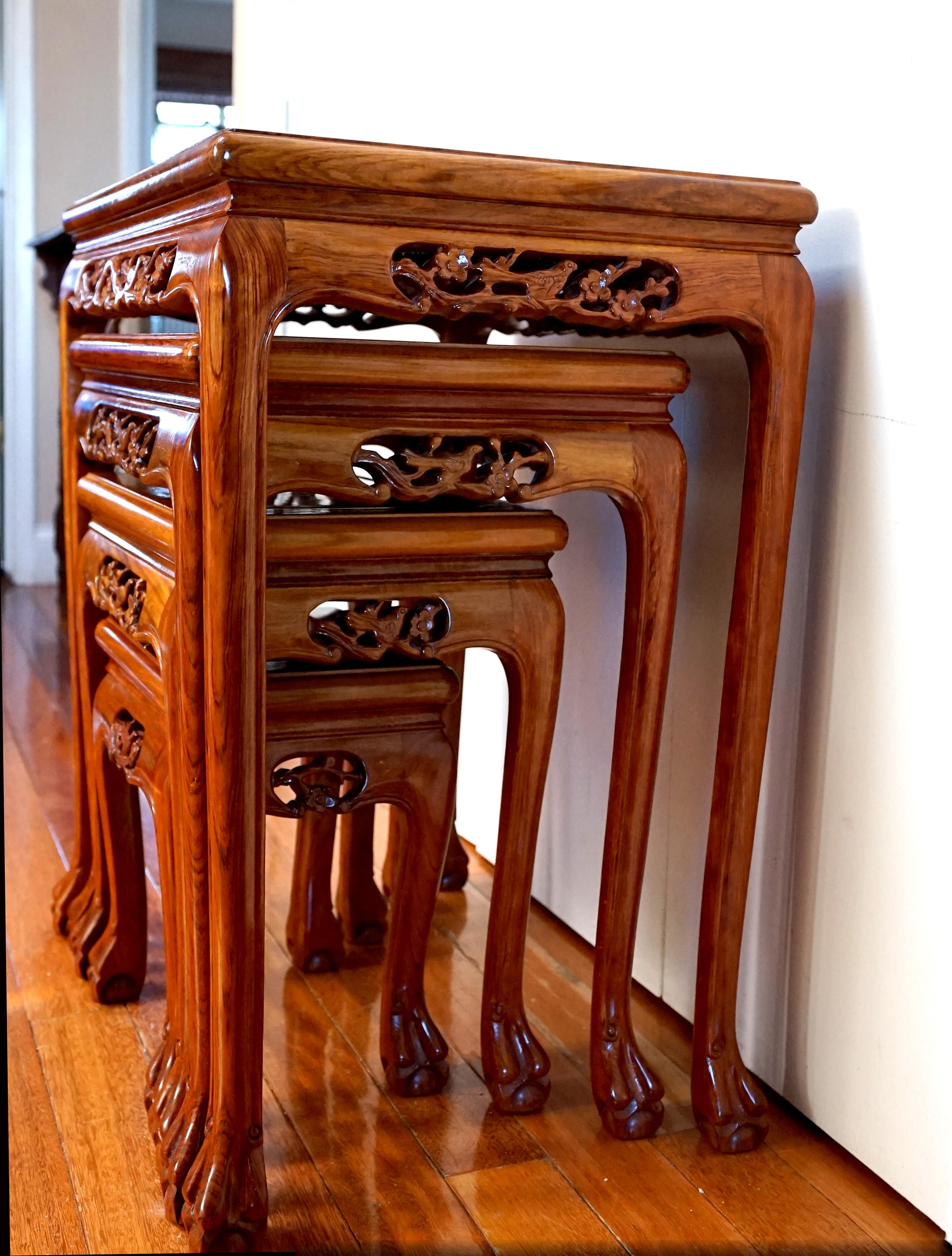 This is a rare find--a beautiful set of rosewood tables (4) with mother-of-pearl inlay. A nest of four Chinese export carved and mother-of-pearl inlaid rosewood side tables 
for the export market, early to mid 20th Century can add design mileage to