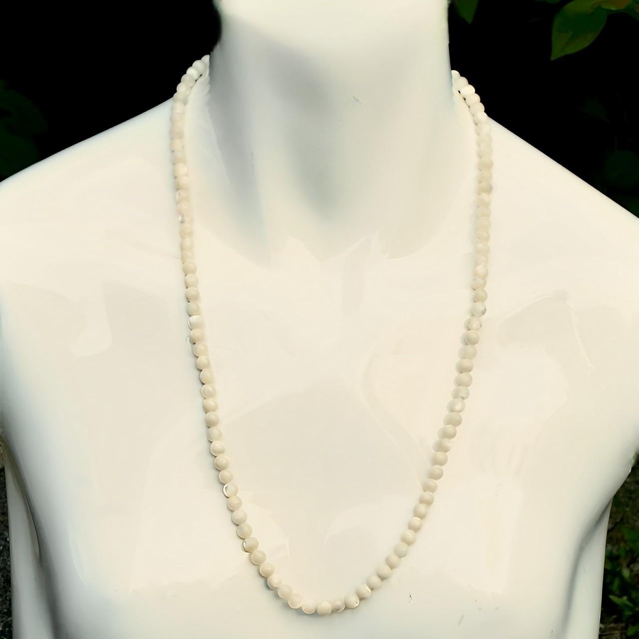 Lovely mother of pearl necklace with round beads and a silver clasp stamped 'sterling'. Measuring necklace length 62.5 cm / 24.6 inches, and the beads are 5.75 mm / .22 inch. The silver clasp works well. The necklace is in very good condition.

This
