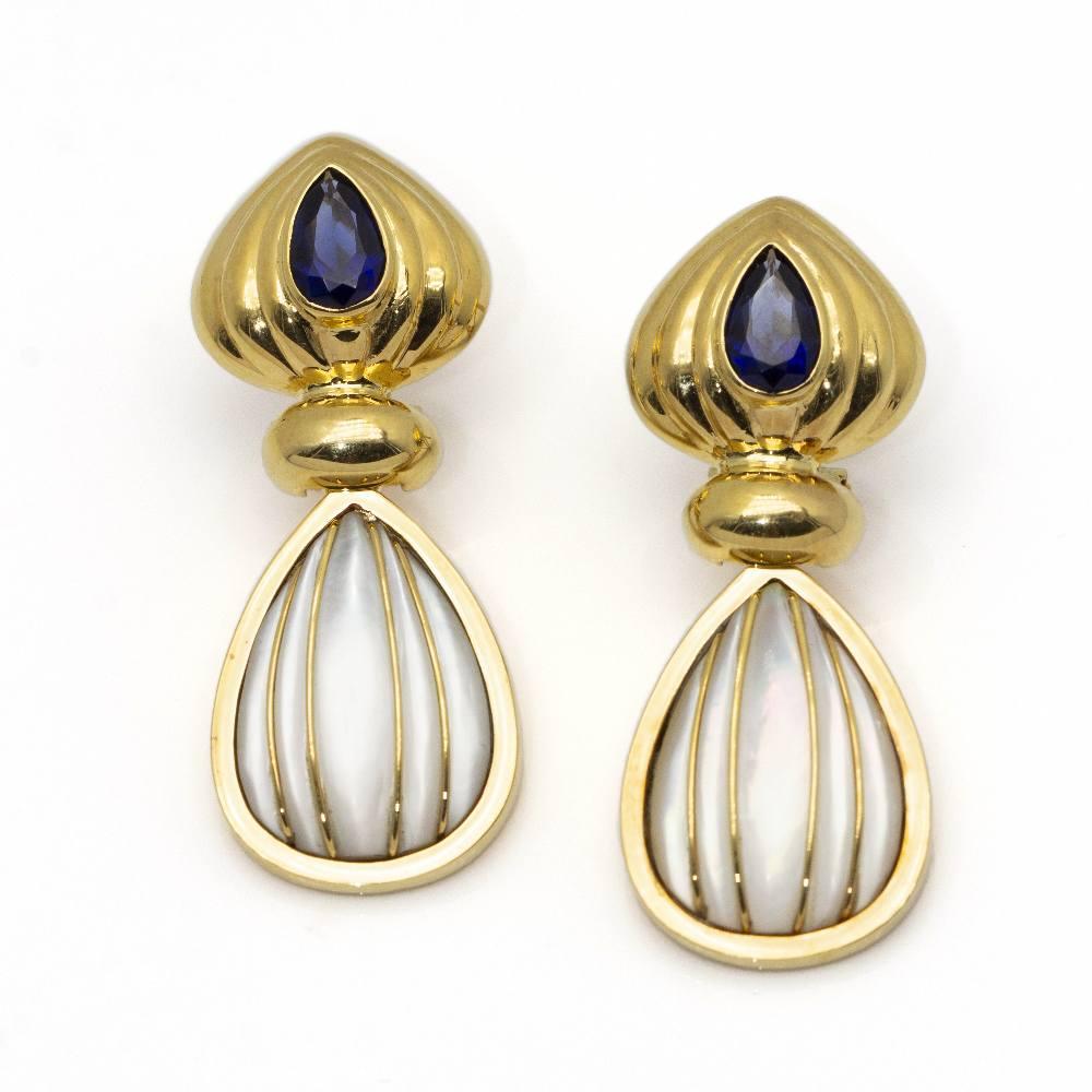Earrings in Gold, Mother of Pearl and Sapphire for woman  Omega clasp  18kt Yellow Gold  12,69 grams  Semi hollow  Measures: Length 4cm, Width 1,7cm  Brand new product only available on the web  Ref.Gold, Mother of pearl and sapphire earrings for
