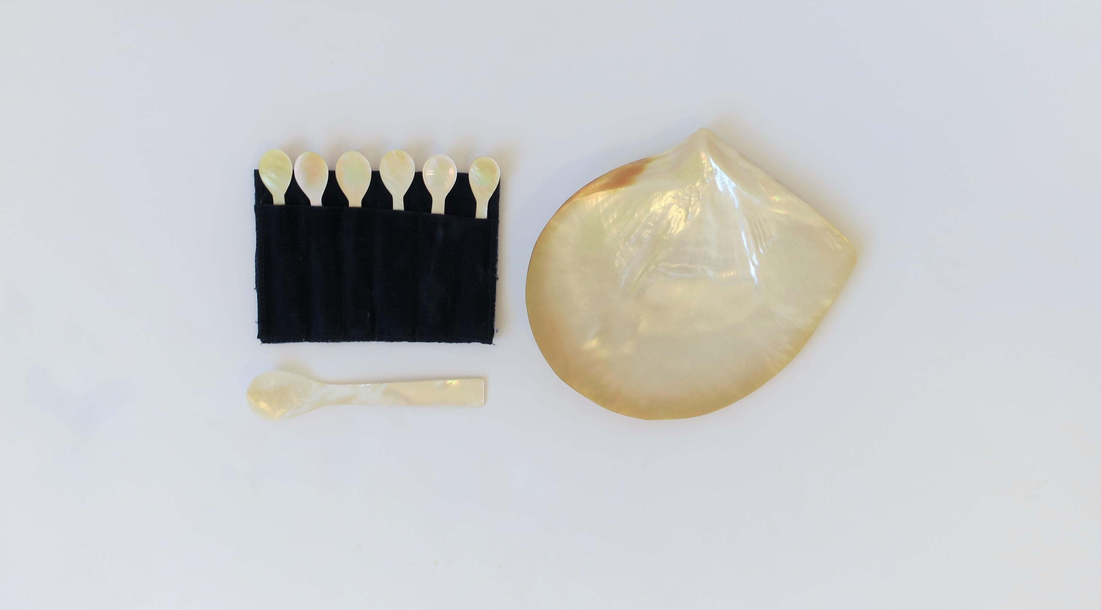 A beautiful Mother-Of-Pearl sea shell caviar set. Set is comprised of 1 dish, 1 serving spoon and 6 individual spoons. 8 pieces in total as show in images. 

Antique Fish & Coral plates shown in image #9 also available, search 1stdibs ID#: