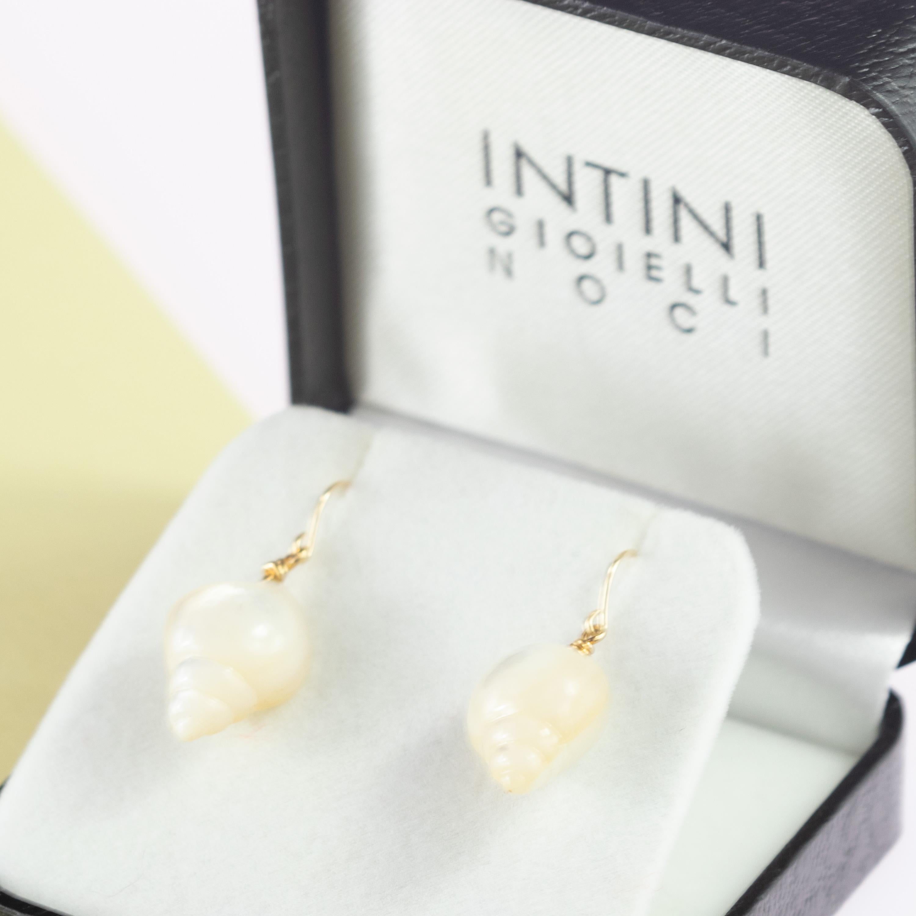 Glamorous mother of pearl shell shaped earrings with a sterling silver joint and 18 karat yellow gold ear wires.  These armonious mother of pearl shells move subtly for a fresh and fashionable look. Inspired by the delicacy of the sea and the soft