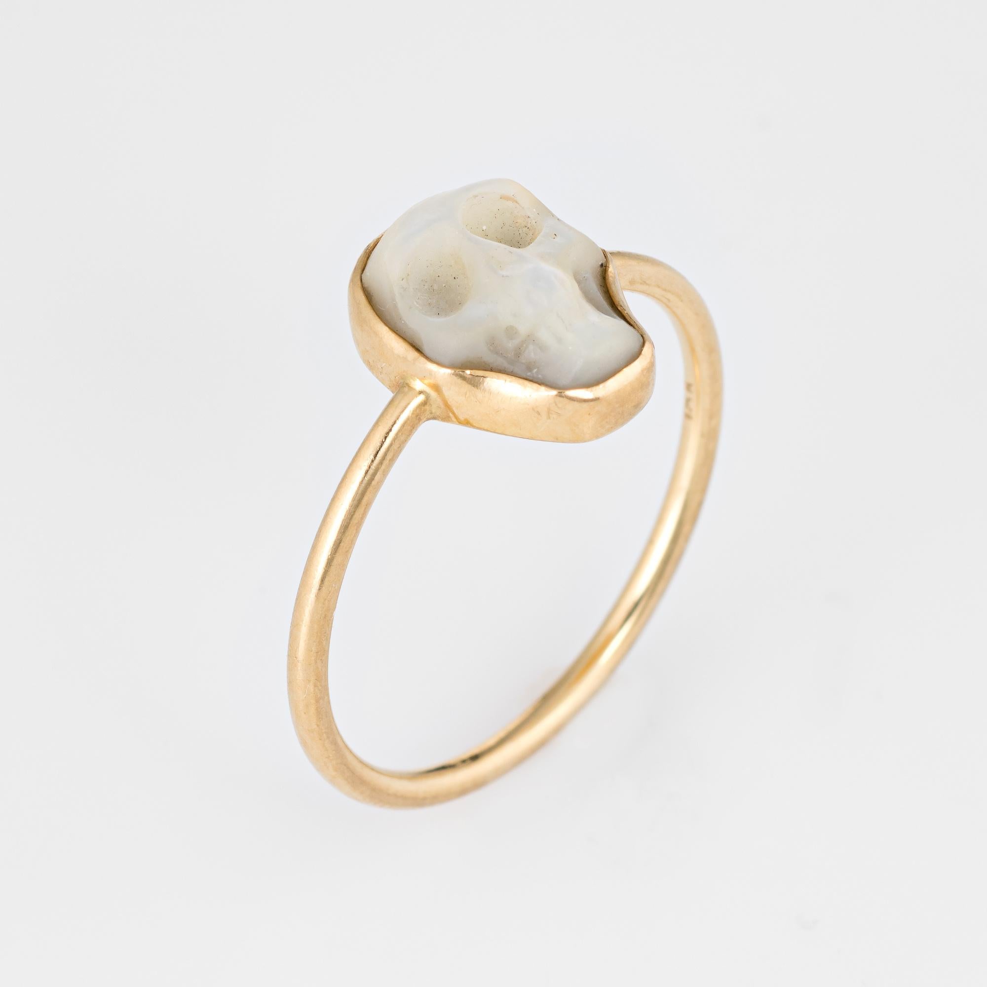 Stylish mother of pearl skull ring crafted in 18 karat yellow gold. 

Mother of pearl is carved in the form of a skull (measuring 10mm x 6mm). The mother of pearl is in excellent condition and free of cracks or chips. 

Luminous mother of pearl