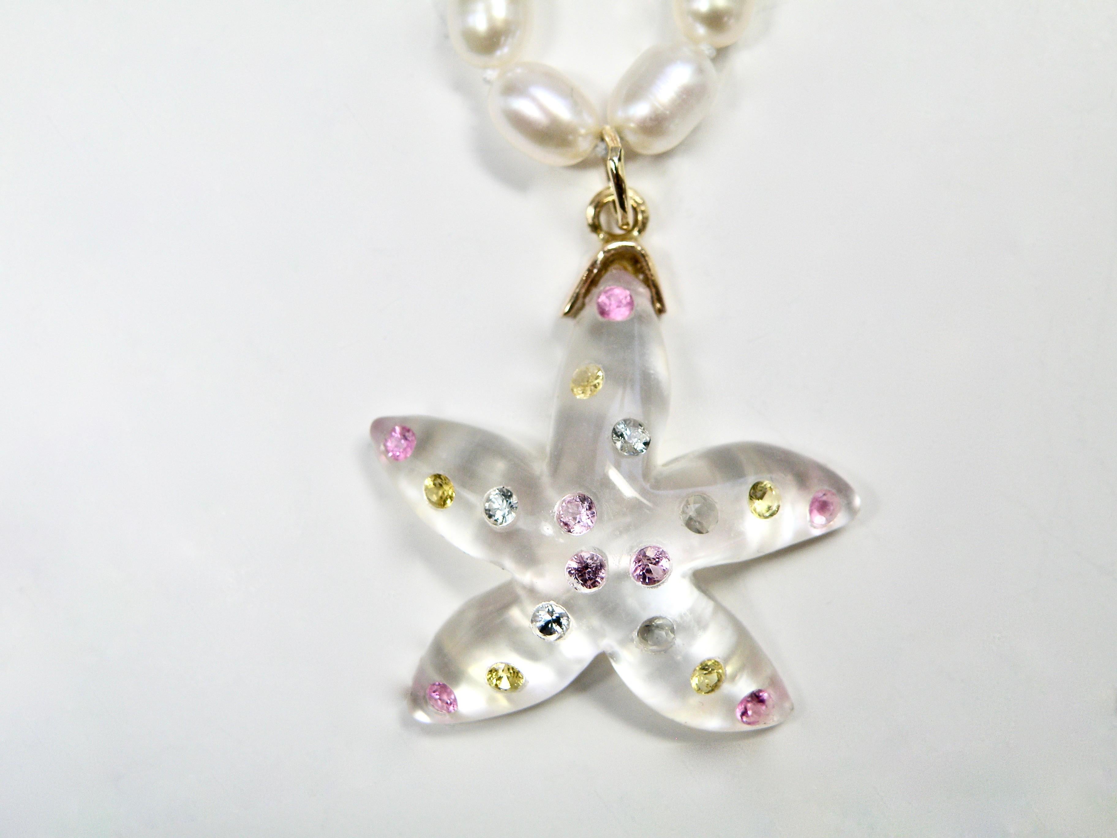 18 karat & 24mm mother of pearl starfish pendant inlaid with 2mm aquamarine & pink tourmaline gemstones 