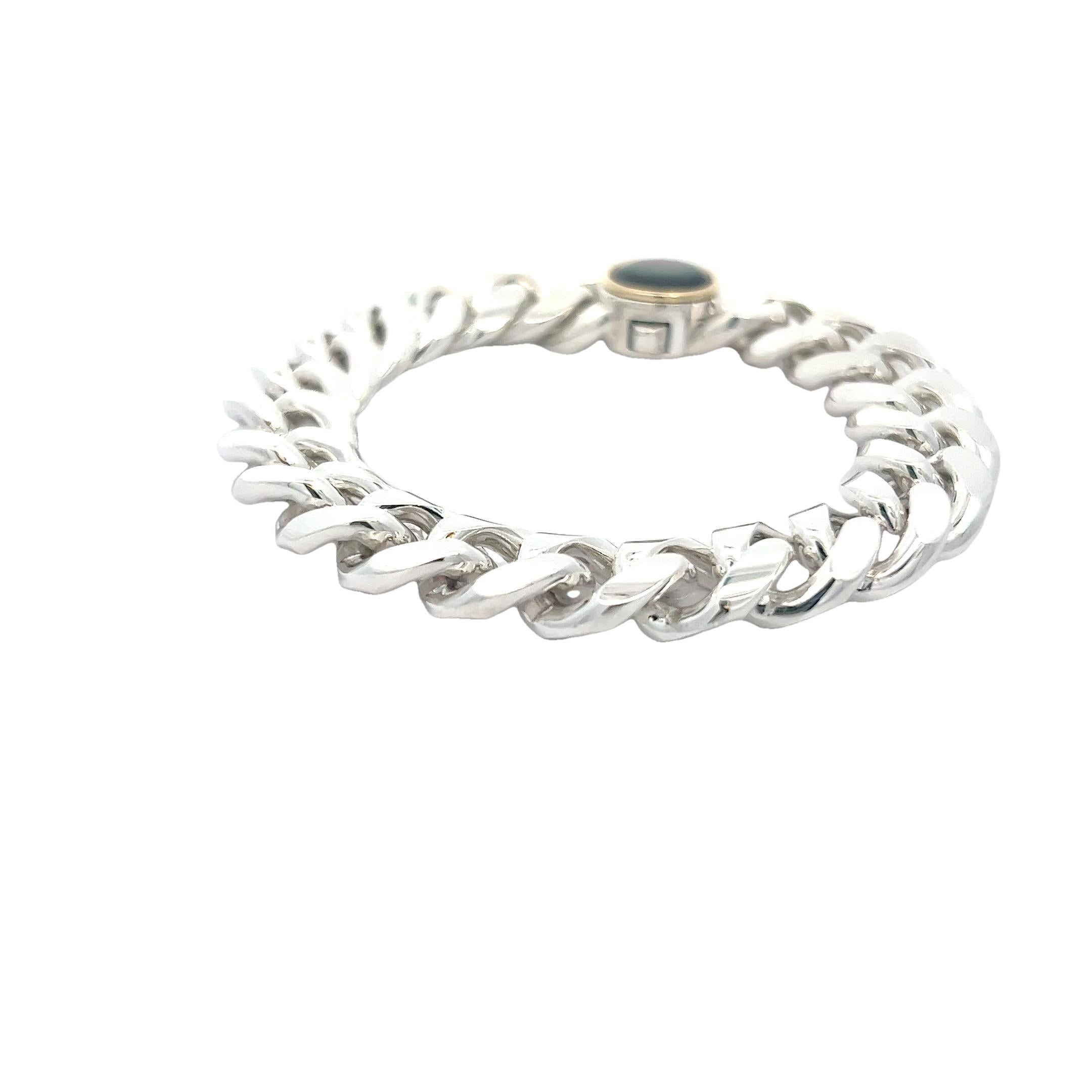 Elevate your wrist with our extraordinary Sterling Silver Cuban Link Chain Bracelet, featuring a mesmerizing Mother-of-Pearl lock adorned with an opulent 18k yellow gold bezel. This bracelet is the epitome of bold and timeless elegance, designed for