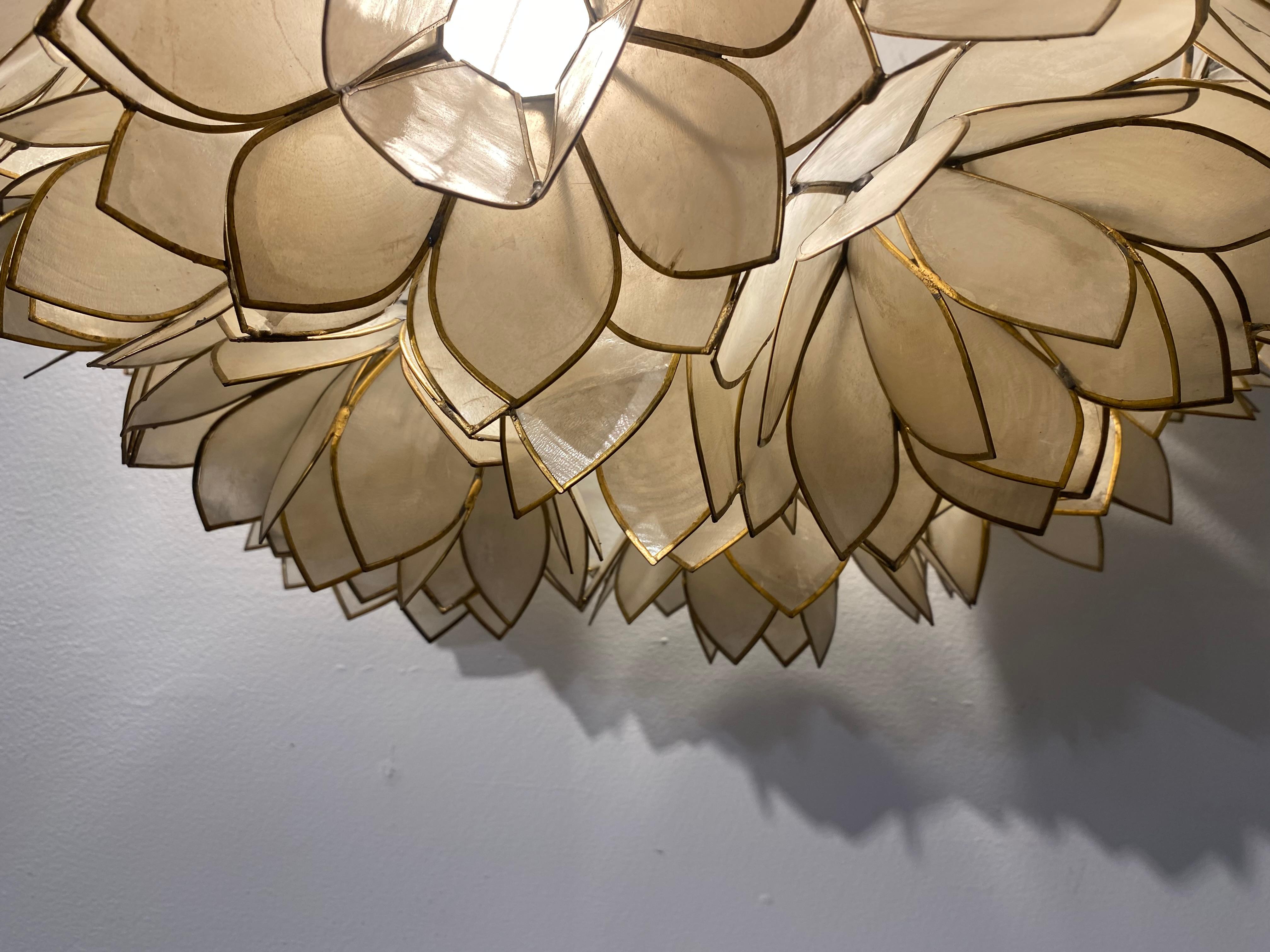Elegant mid-century Belgian work with mother of pearl and metallic structure. This flower lamp could be used as an amazing wall lamp or a ceiling lamp. Each petal proposes a unique color, light switched on or switched off.
The size of this piece is