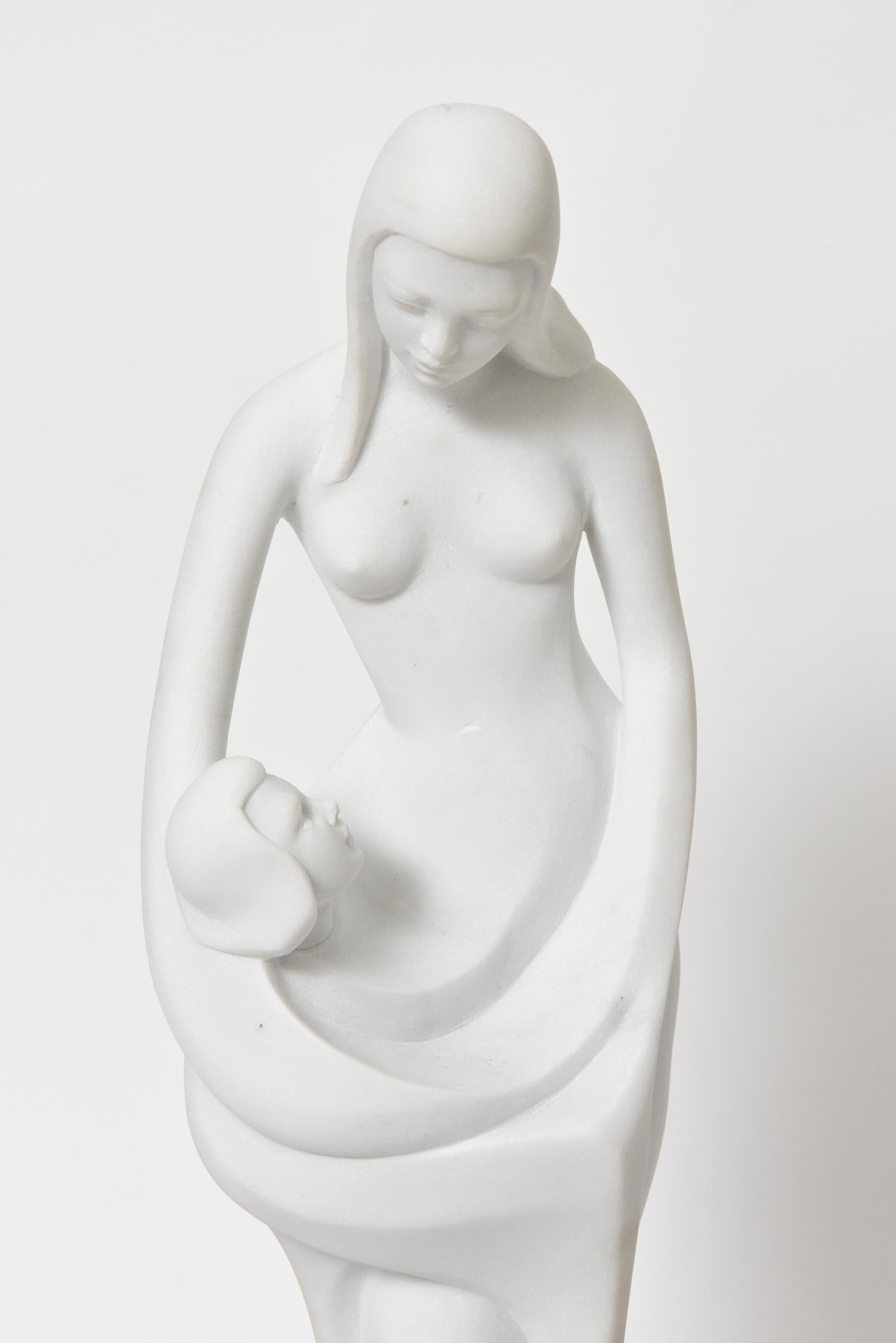 Enzo Gallo carved this abstract marble sculpture of a child intertwined in its mother's body. 

Enzo Gallo (b. 1927 Italy) is a visual artist who has worked primarily in Marble and Bronze. He is considered a master Sculptor, and has had a number