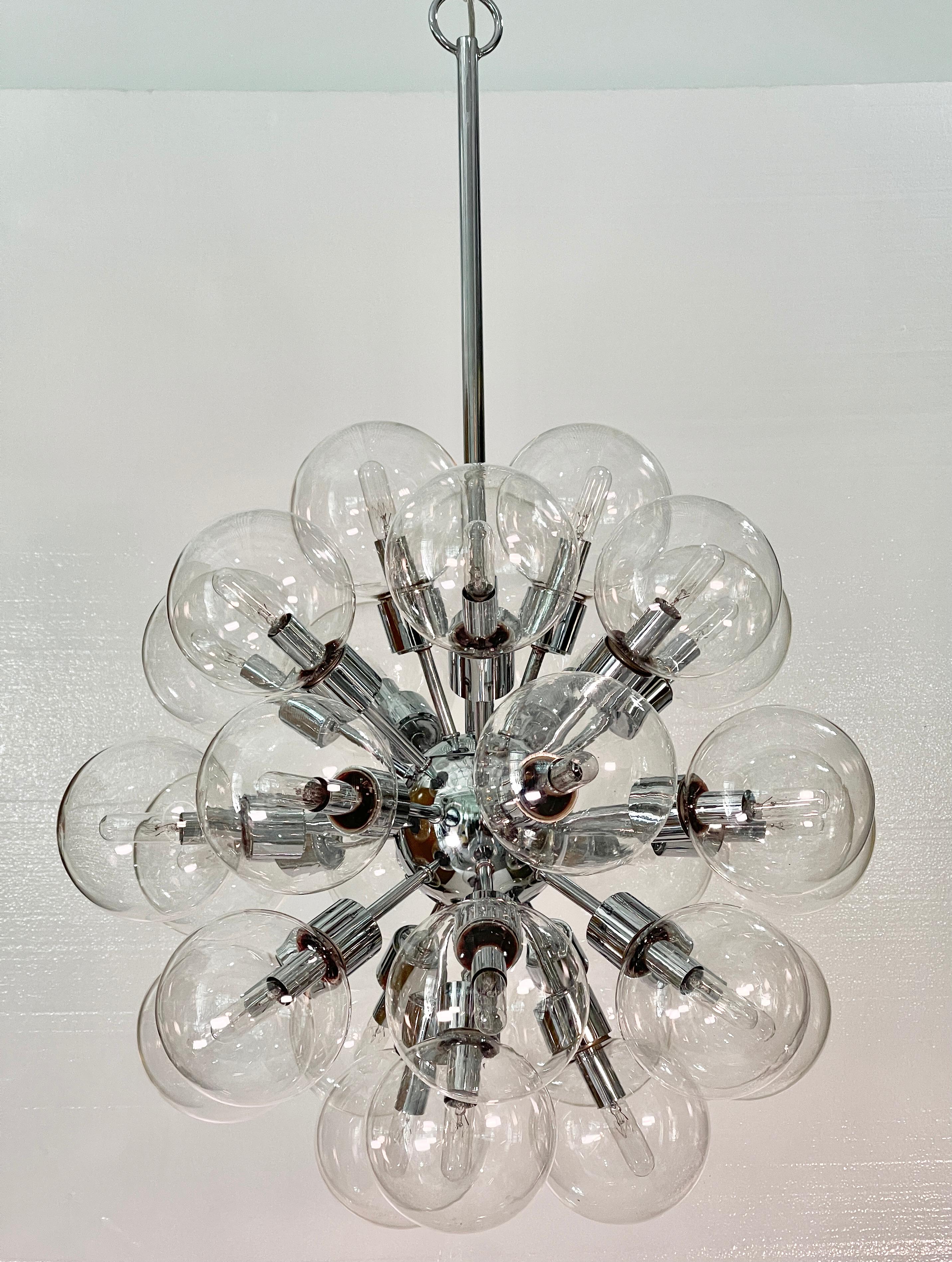 From the Space Crystal collection designed by Motoko Ishii, the multi-award winning savant of architectural lighting, created in 1972 for West German firm Staff Leuchten.. 
This UL certified hefty chrome plated sputnik chandelier was produced circa