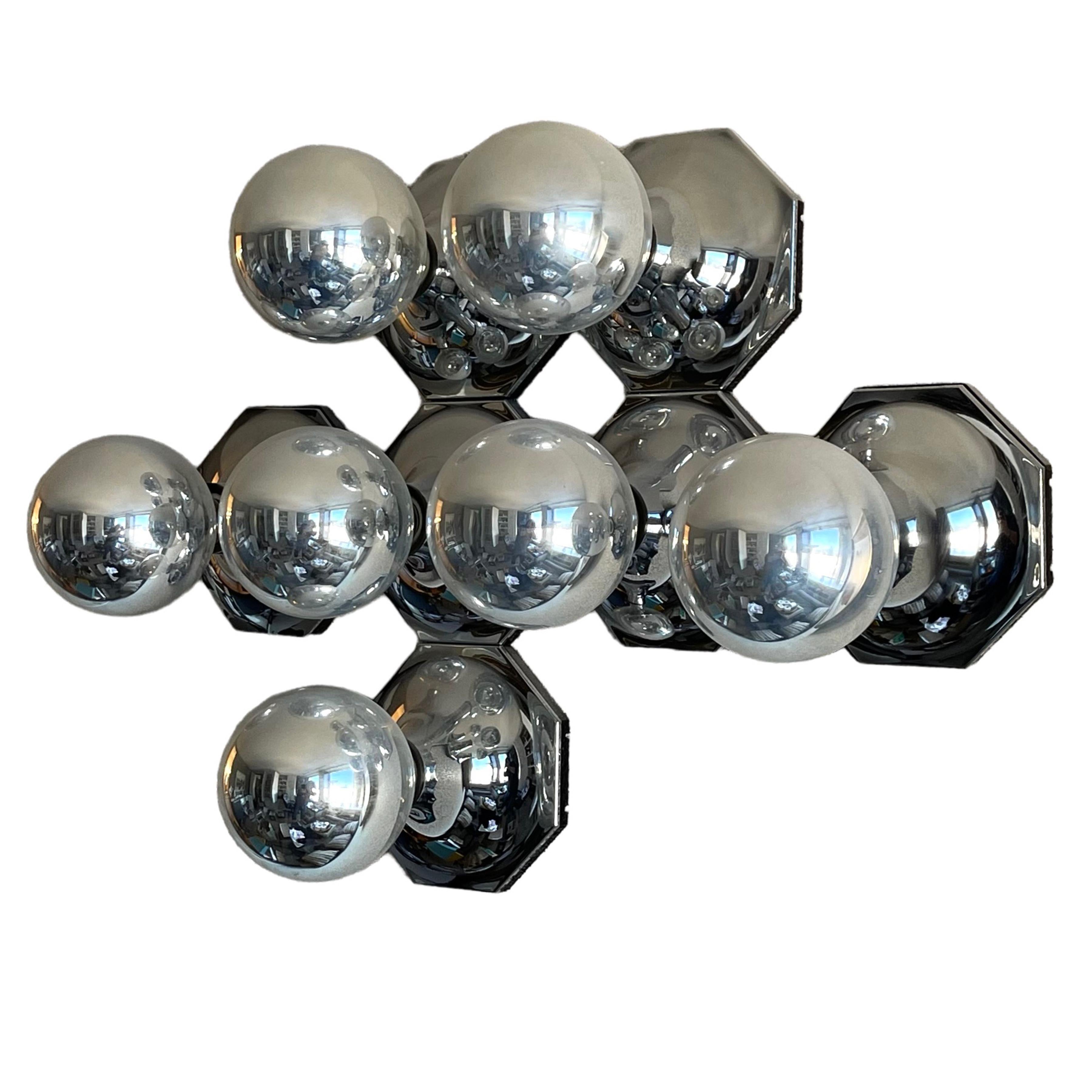 Designed by Motoko Ishii for Staff Leuchten, Germany in the 1970s these terrific lamps are equal parts lighting and sculpture. The bases are made of chrome-plated plastic and metal with a hexagonal form. They can be installed individually, or in